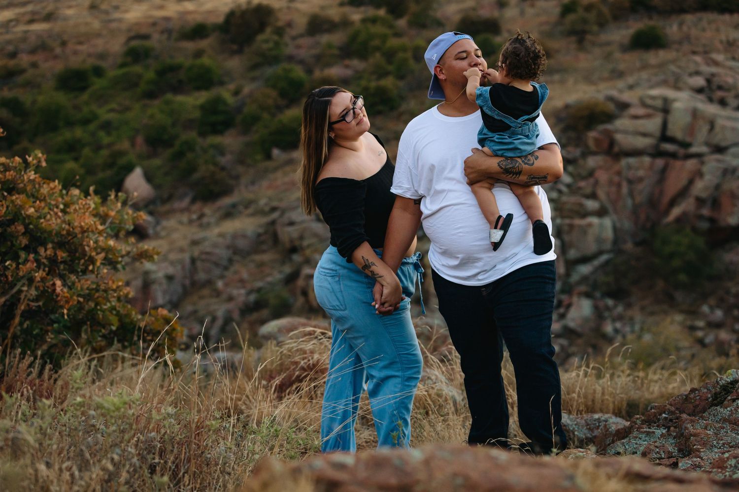 Family enjoying a sunny afternoon outdoors against a desert mountain landscape.