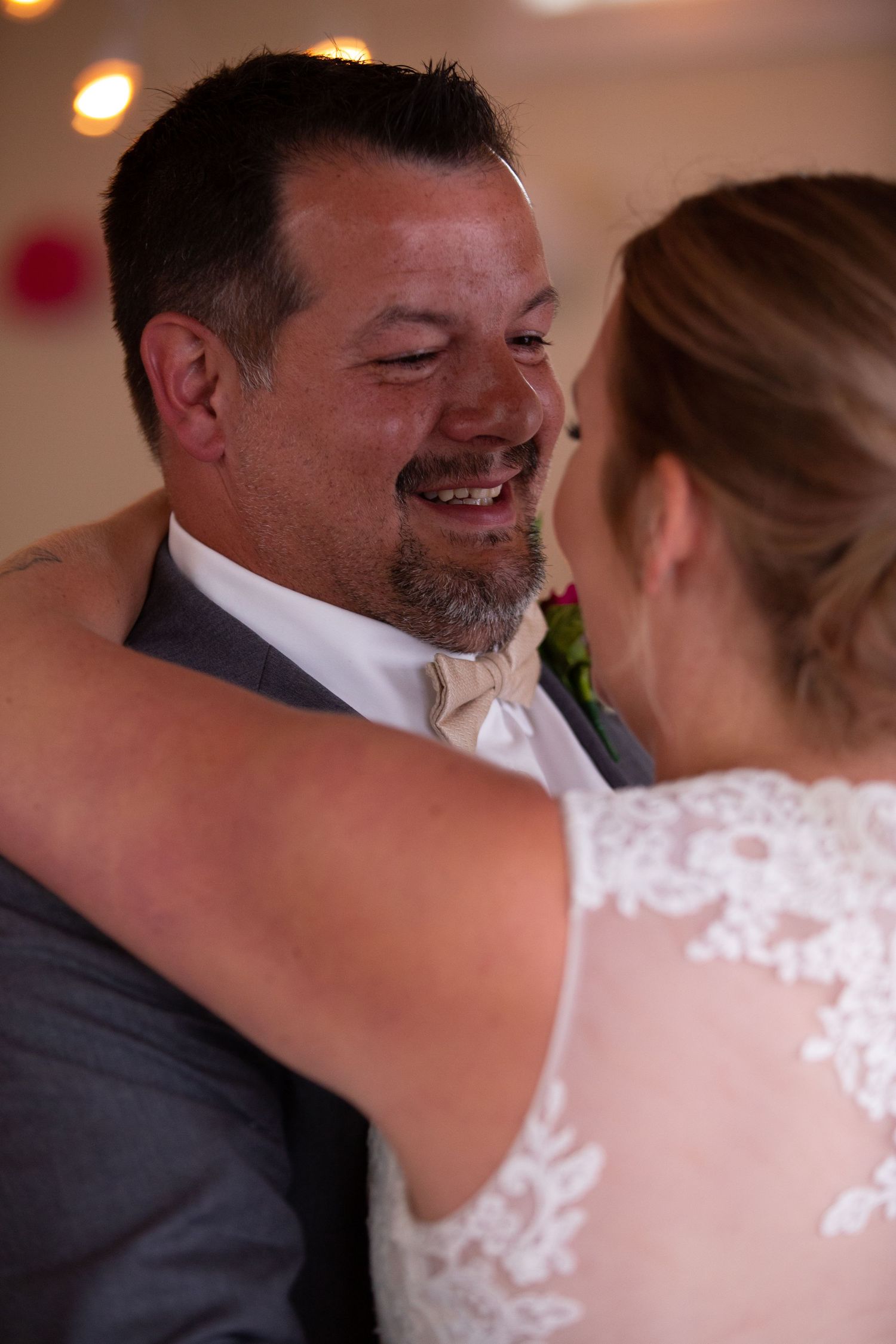 Close-up shot of a tender moment between newlyweds during their first dance.