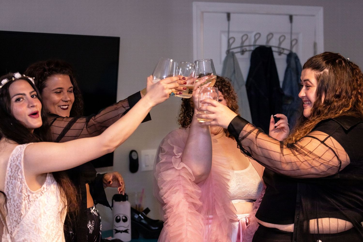 Wedding party celebrating and dancing in formal attire.