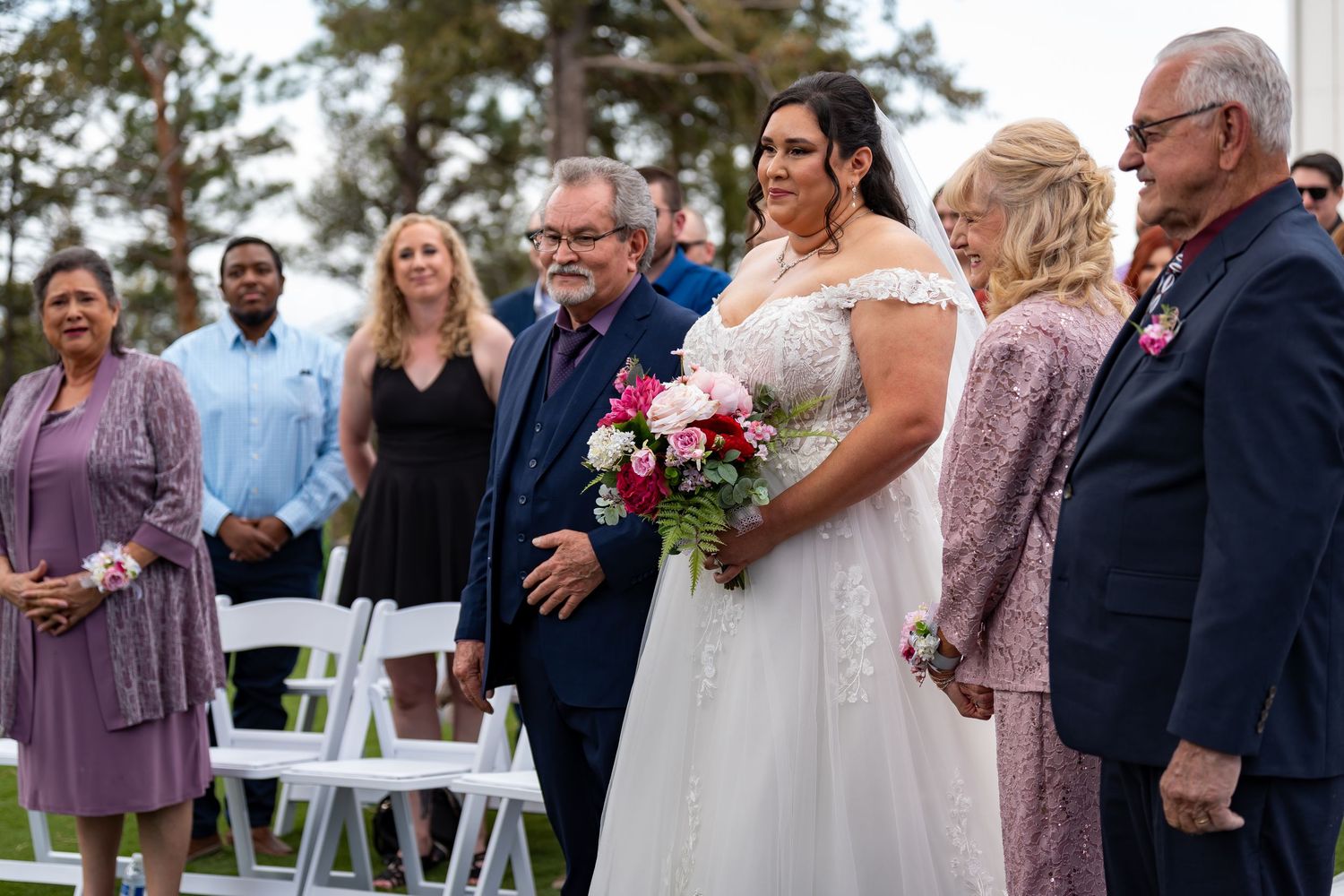Wedding party members gathered outdoors during ceremony celebrations.