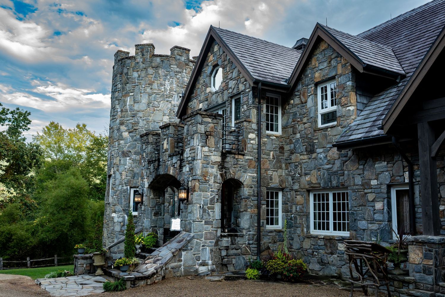 Exterior view of a grand stone castle-like building with multiple wings and architectural details.