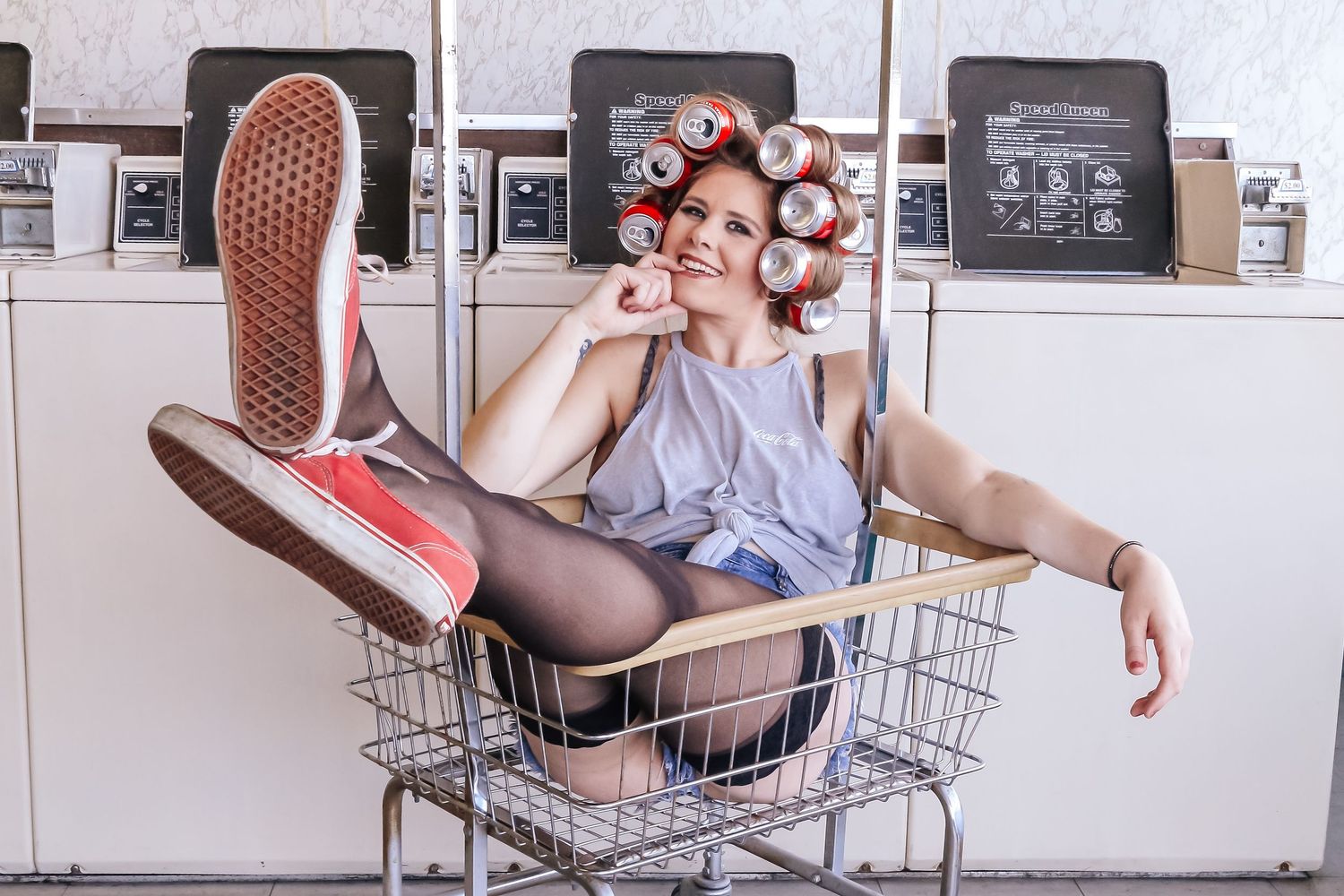 Shopping cart poses in a laundromat with retro washing machines in the background.