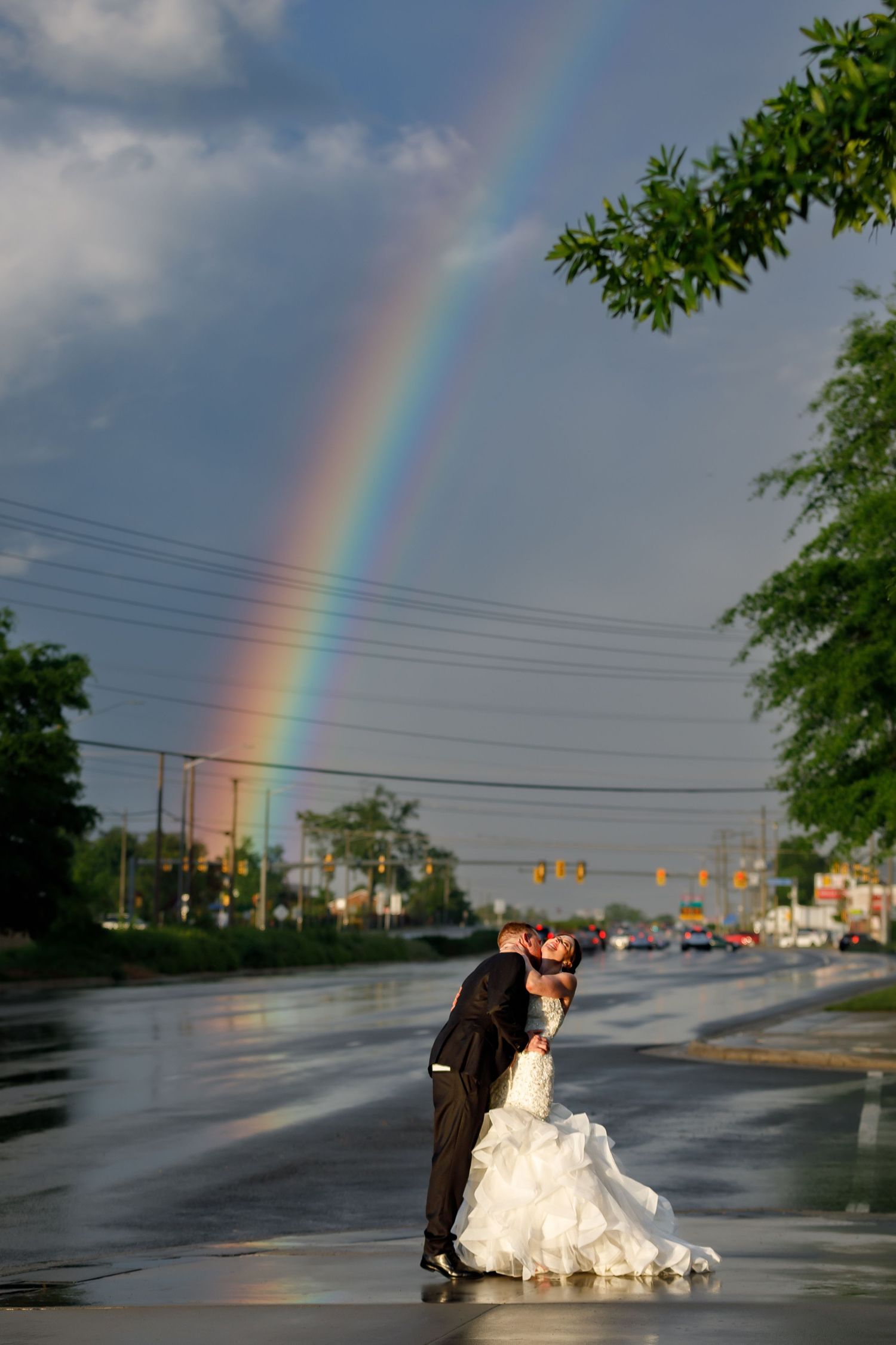 A romantic wedding photoshoot sequence with a rainbow appearing in the background.