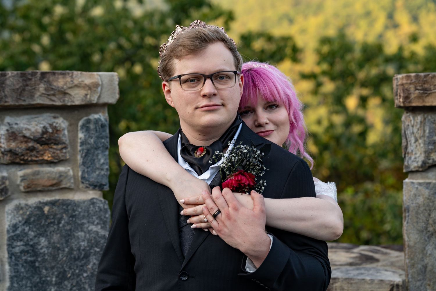 A romantic moment captured between a couple against a scenic autumn mountain backdrop.