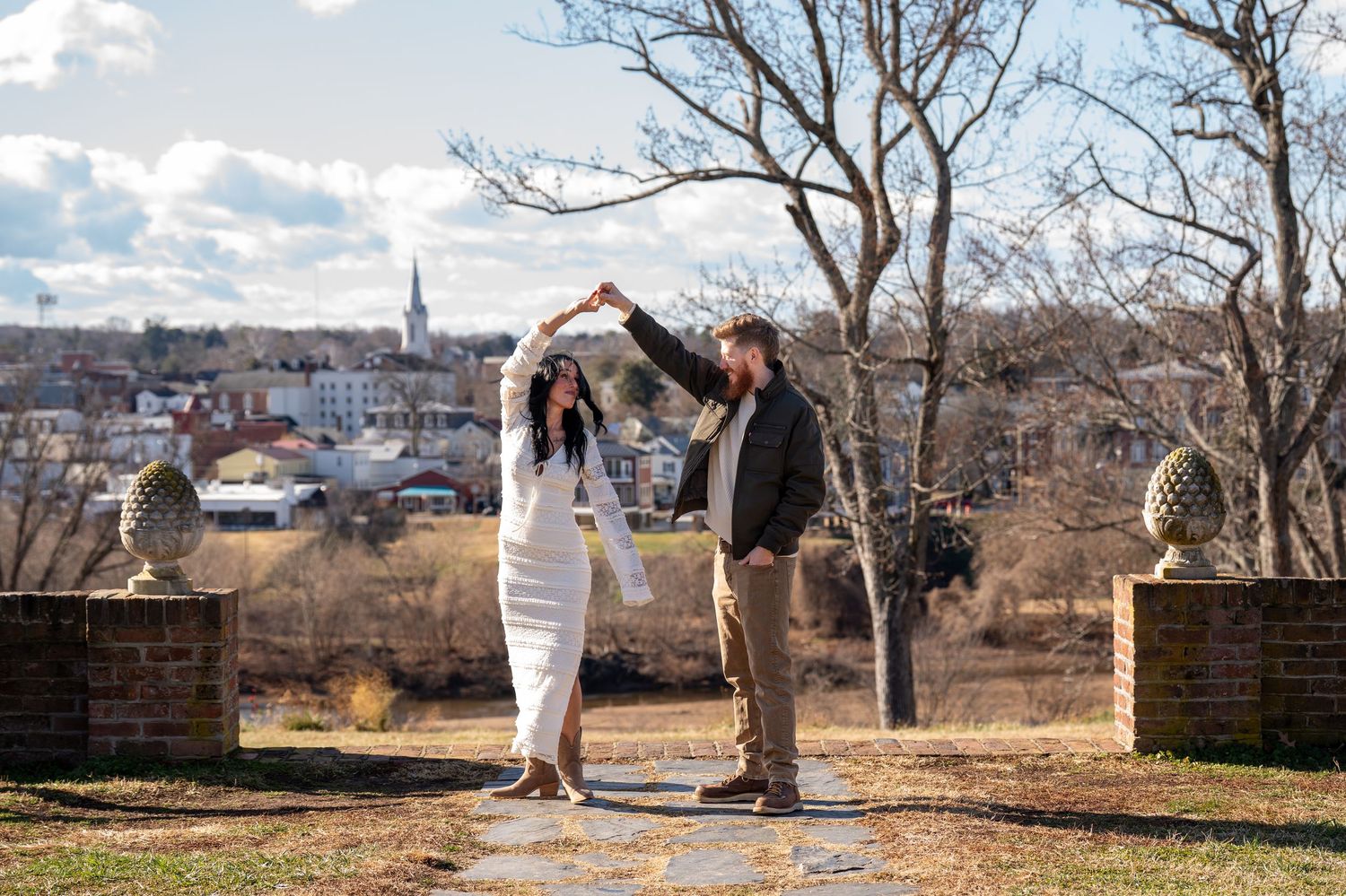 A scenic outdoor photoshoot with city skyline visible in the background on a sunny day.