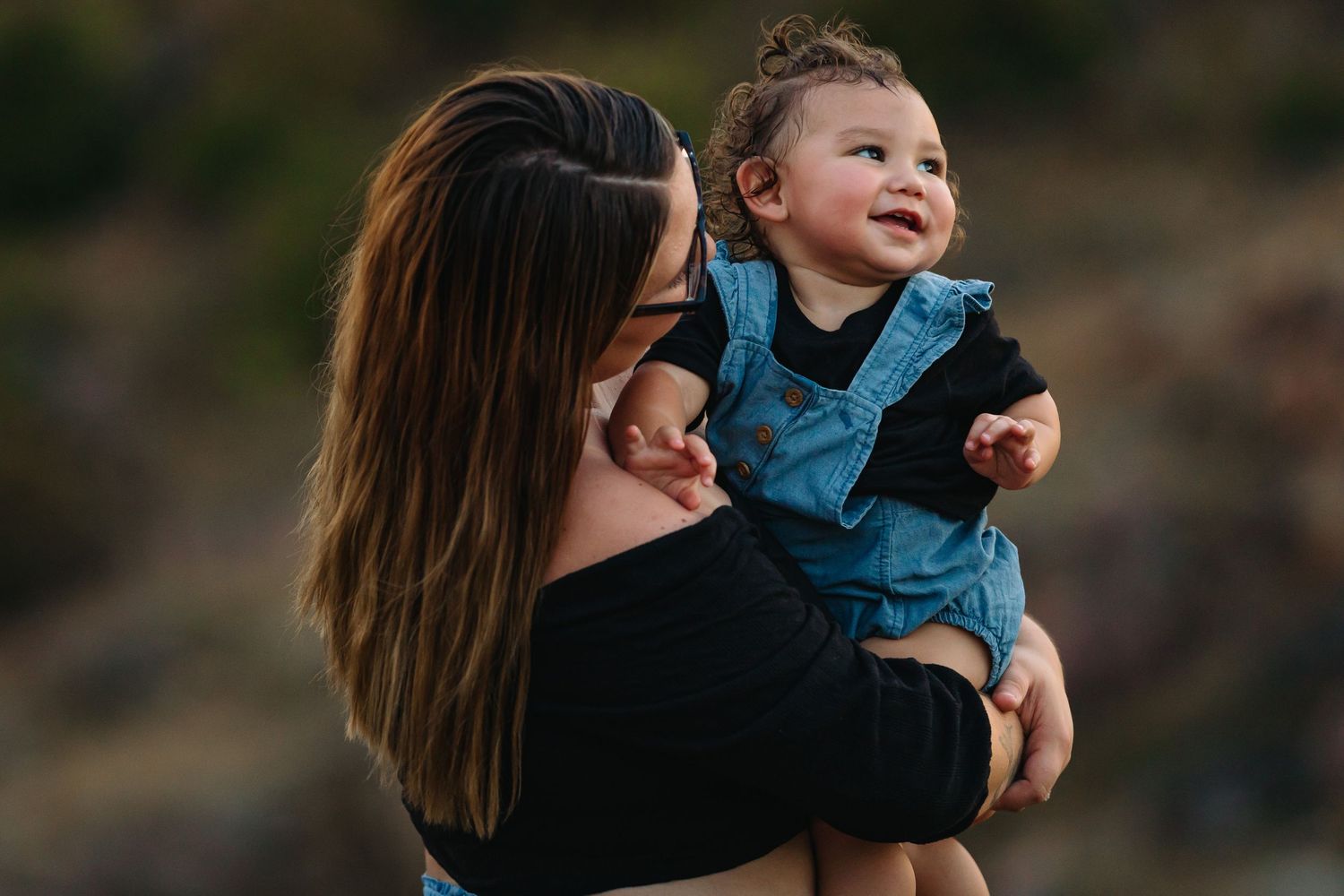 Candid moments of laughter and play captured in a series of outdoor photos.