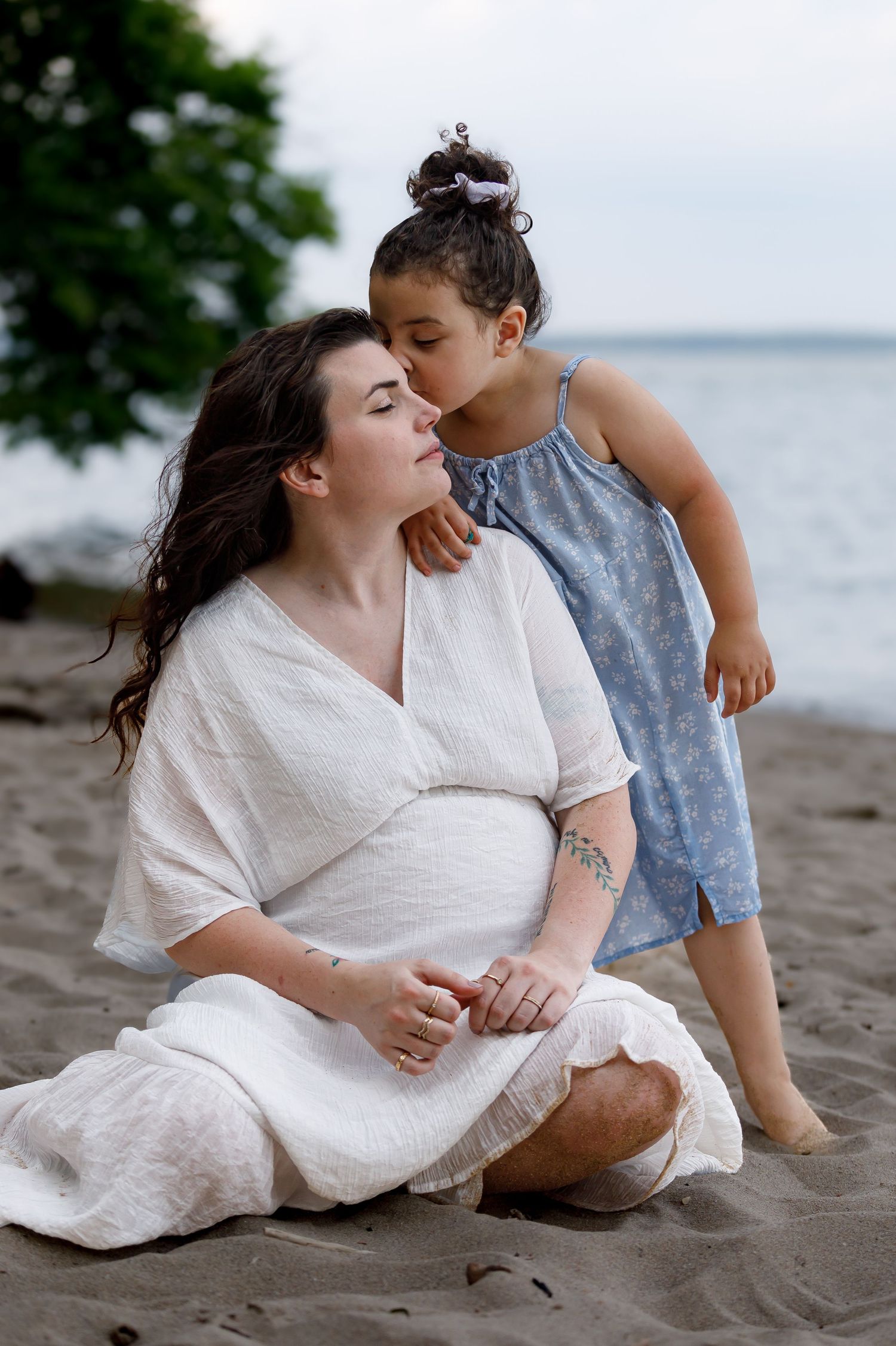 Sweet moment shared between parent and child on a sandy beach.