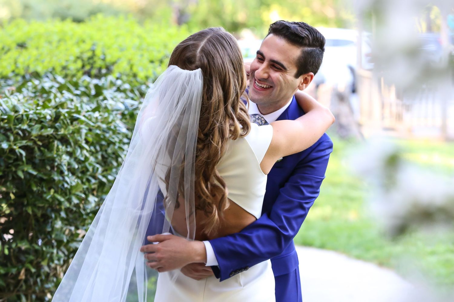 Romantic outdoor wedding photography session in a lush green garden setting.