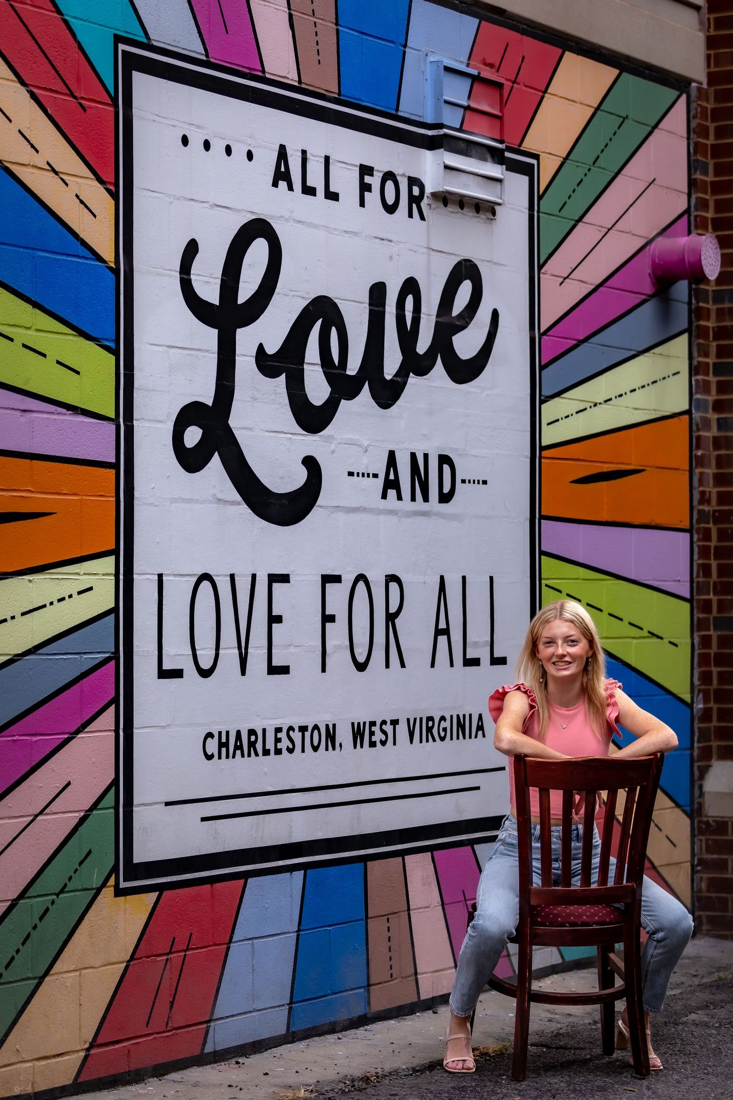 Colorful wall mural reading 'Love for All' in Charleston, West Virginia.