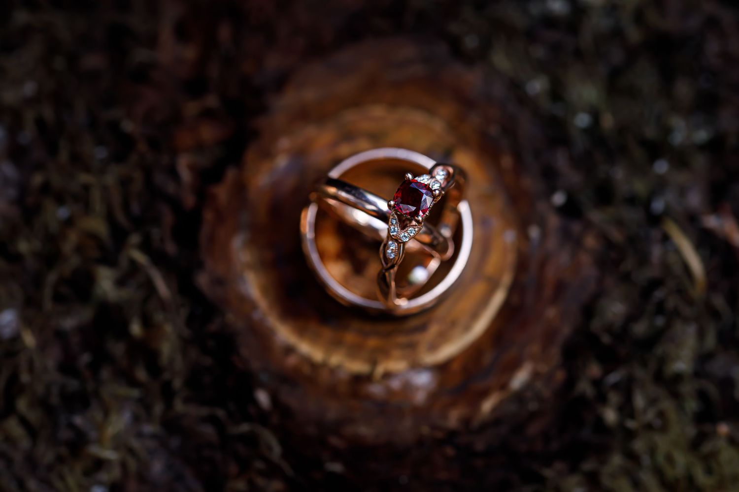Detailed macro photography of water drops creating circular patterns on dark surface.