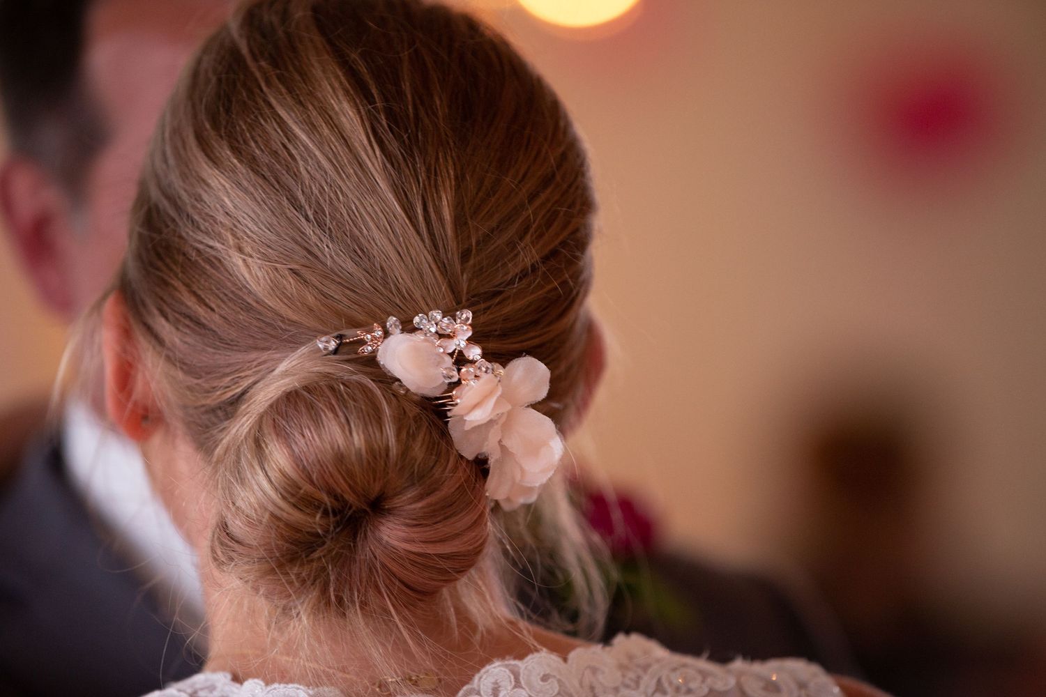 Elegant bridal hairstyle adorned with delicate floral accessories.