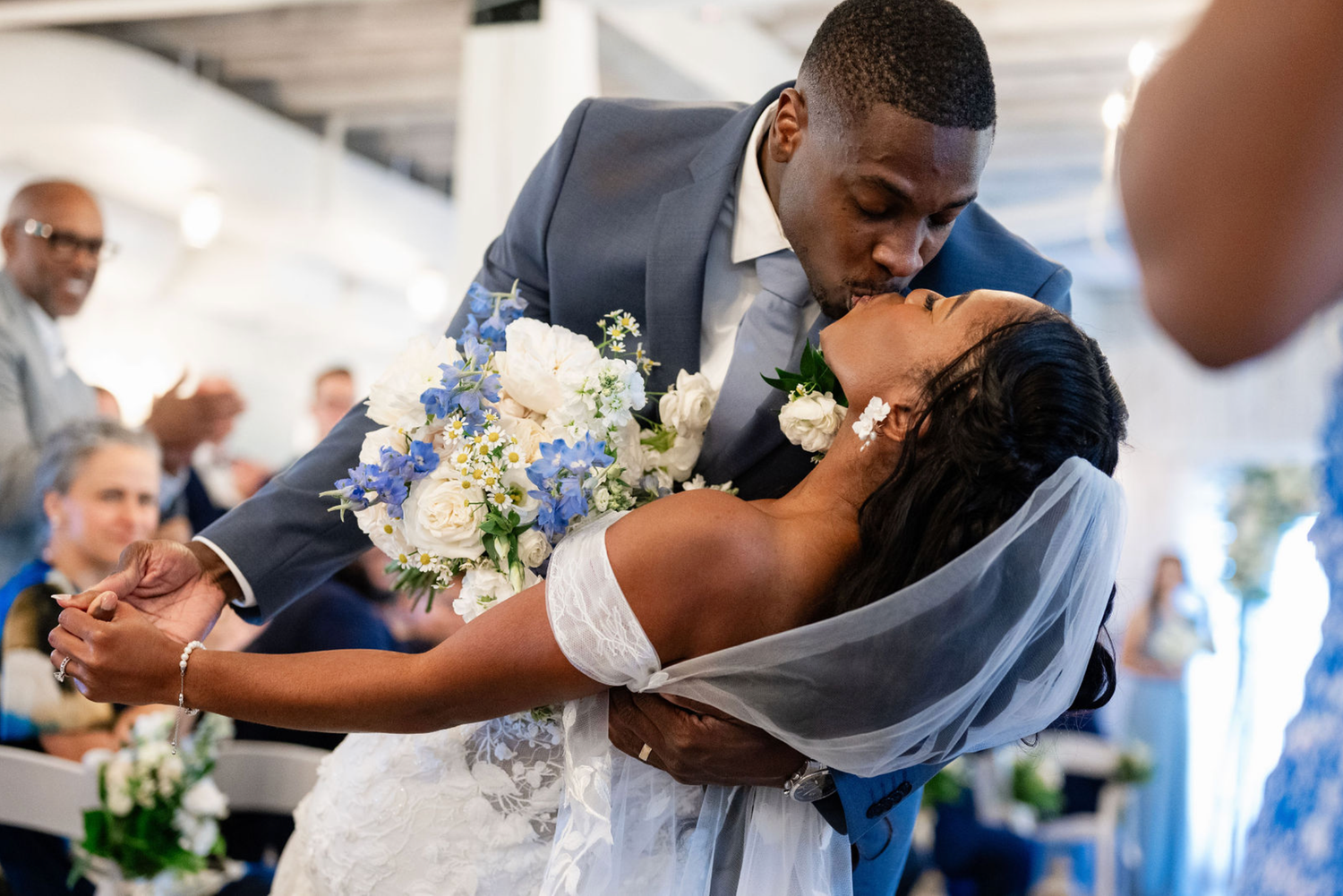 An elegant wedding reception celebration with dancing and floral decorations.