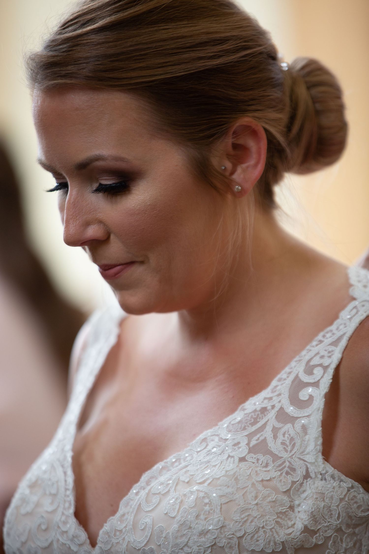 Delicate white lace wedding dress with intricate beading and embroidery details.