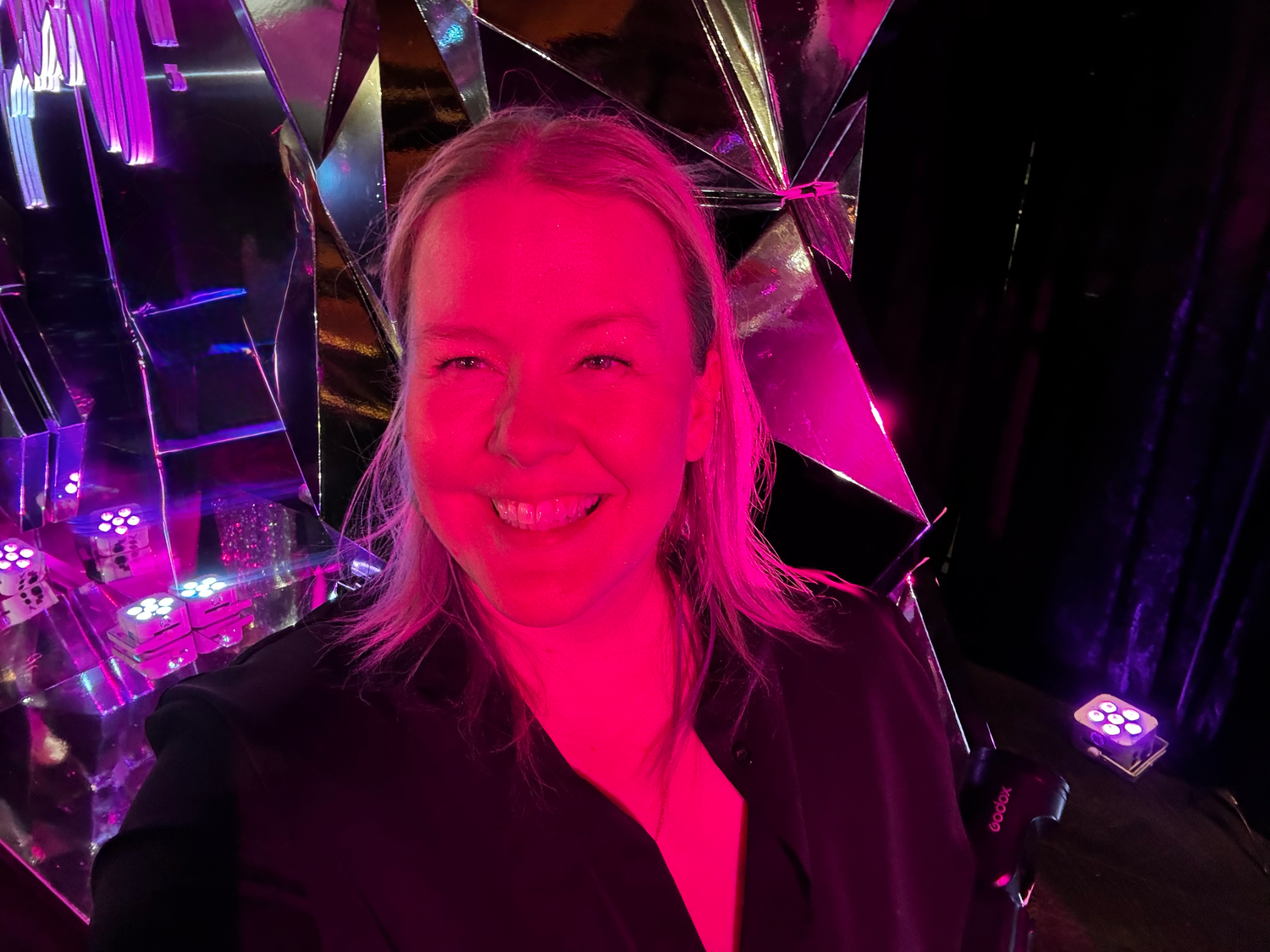 Dance party with pink and purple lighting effects.