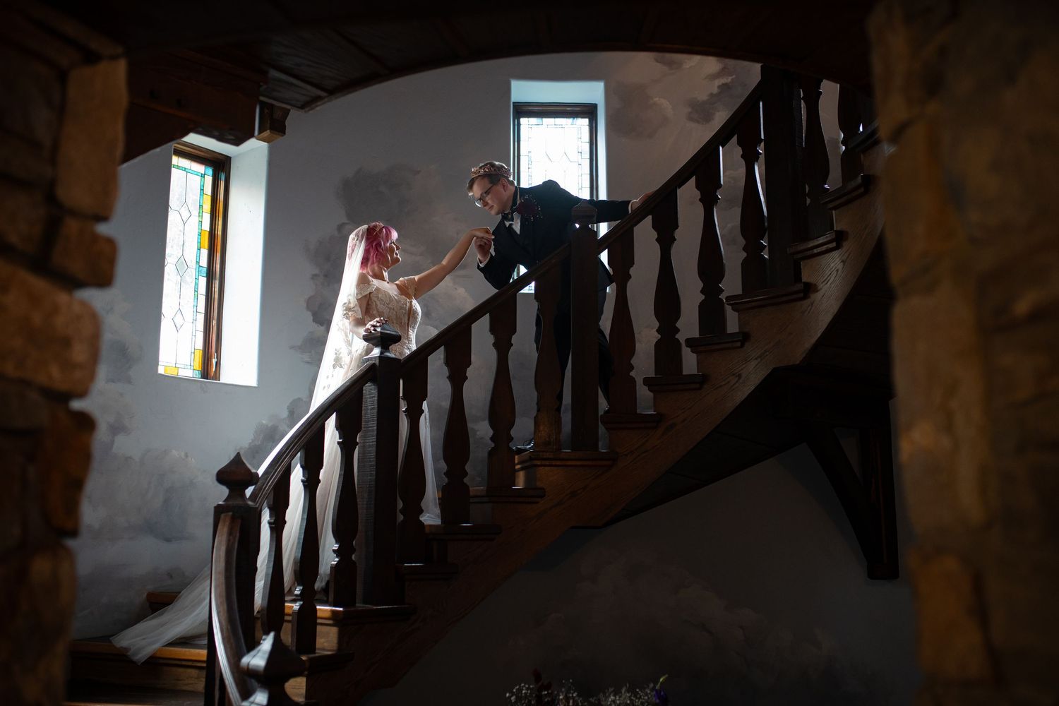 Artistic silhouette of couple on vintage wooden staircase.
