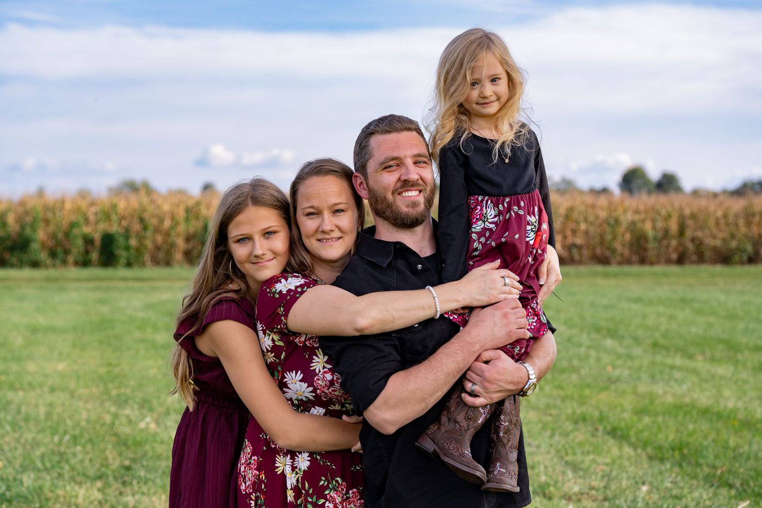 Outdoor portrait session with natural poses against rural landscape.