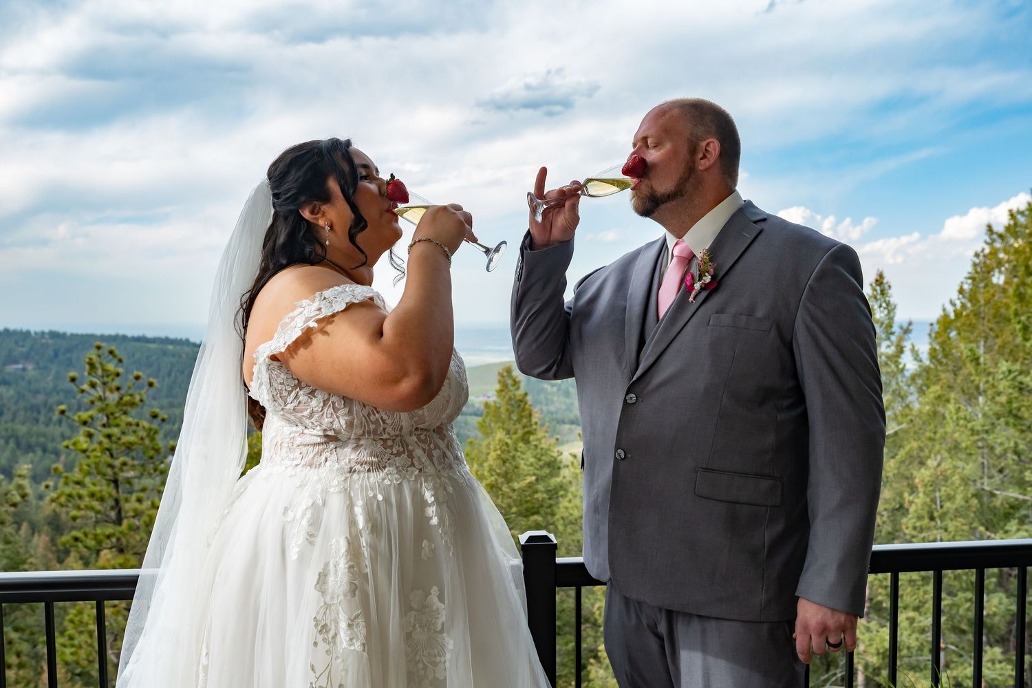 Wedding couple sharing intimate moments on an outdoor terrace with mountain views.