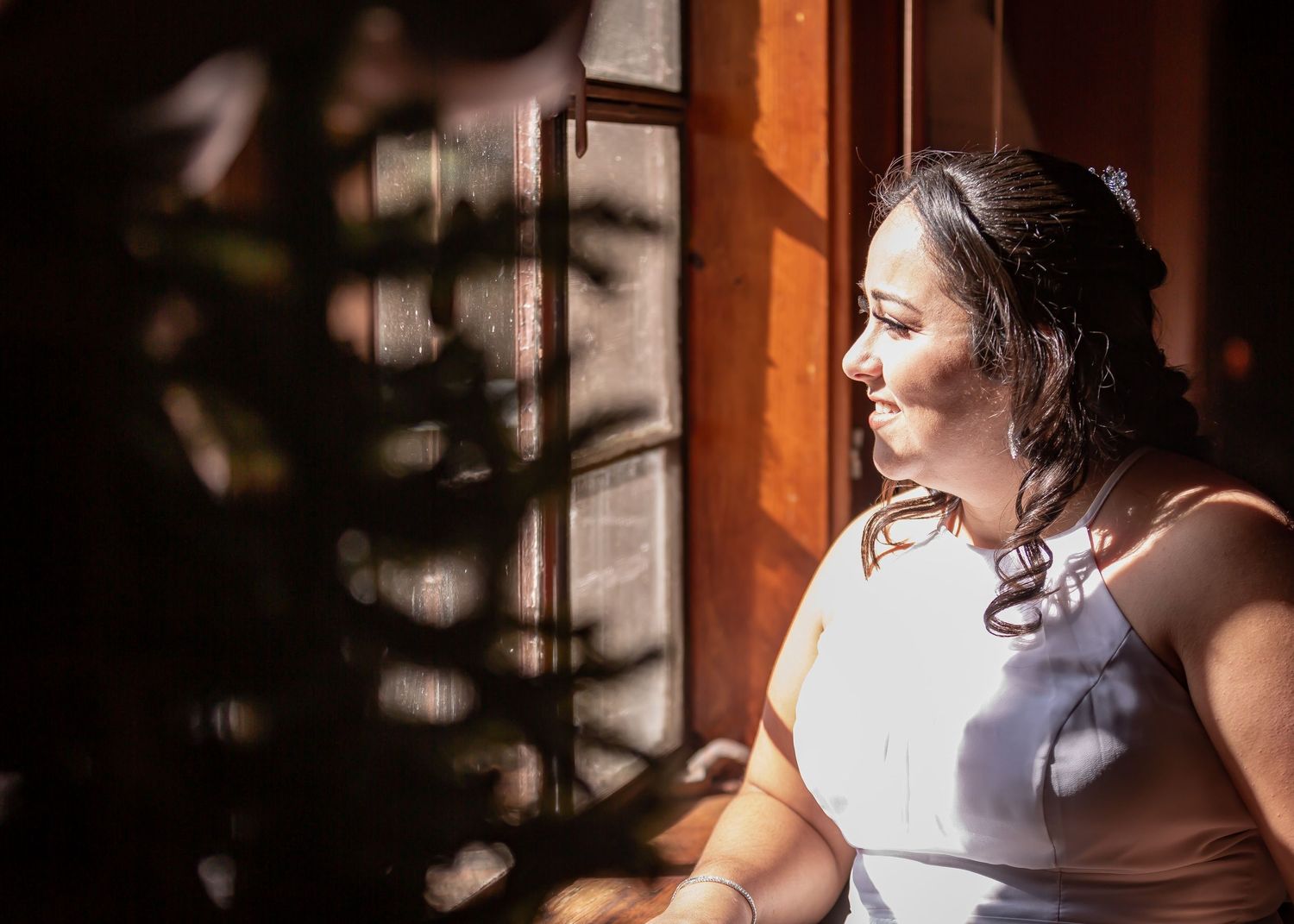 Artistic portrait with dramatic window light and shadow play.