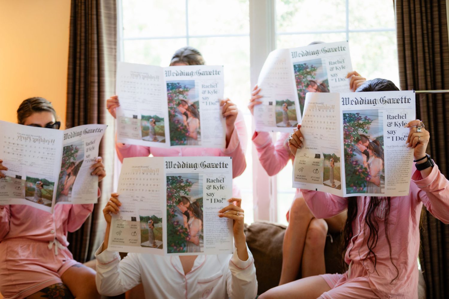 Wedding guests holding up photo story cards in sequence.