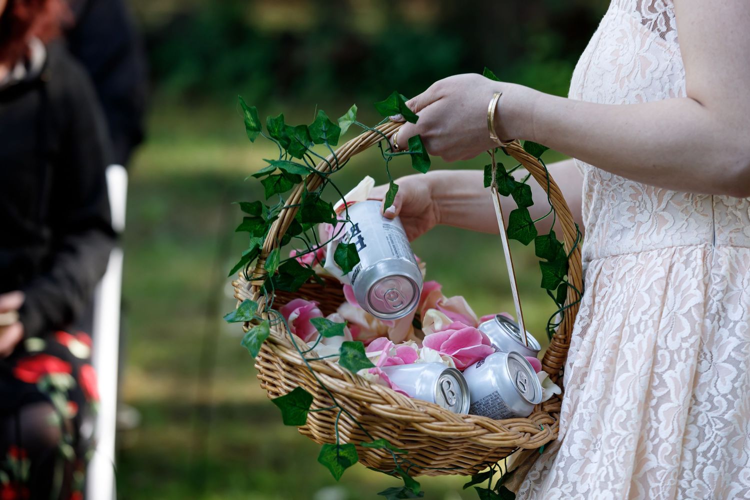 Close-up shots of hands holding a decorative wicker basket with flowers and decorations.