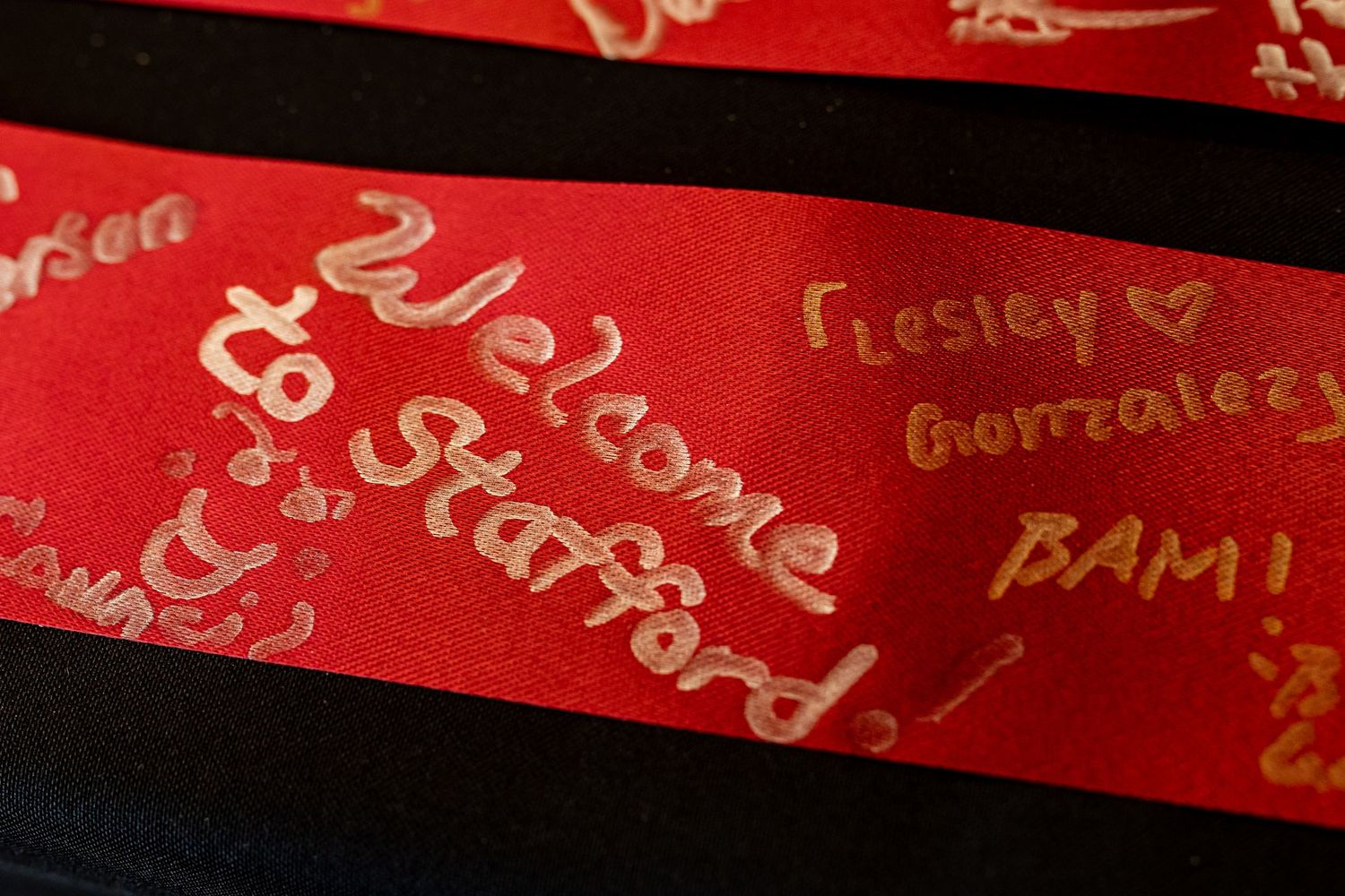 Close-up of red surface with handwritten text and signatures.