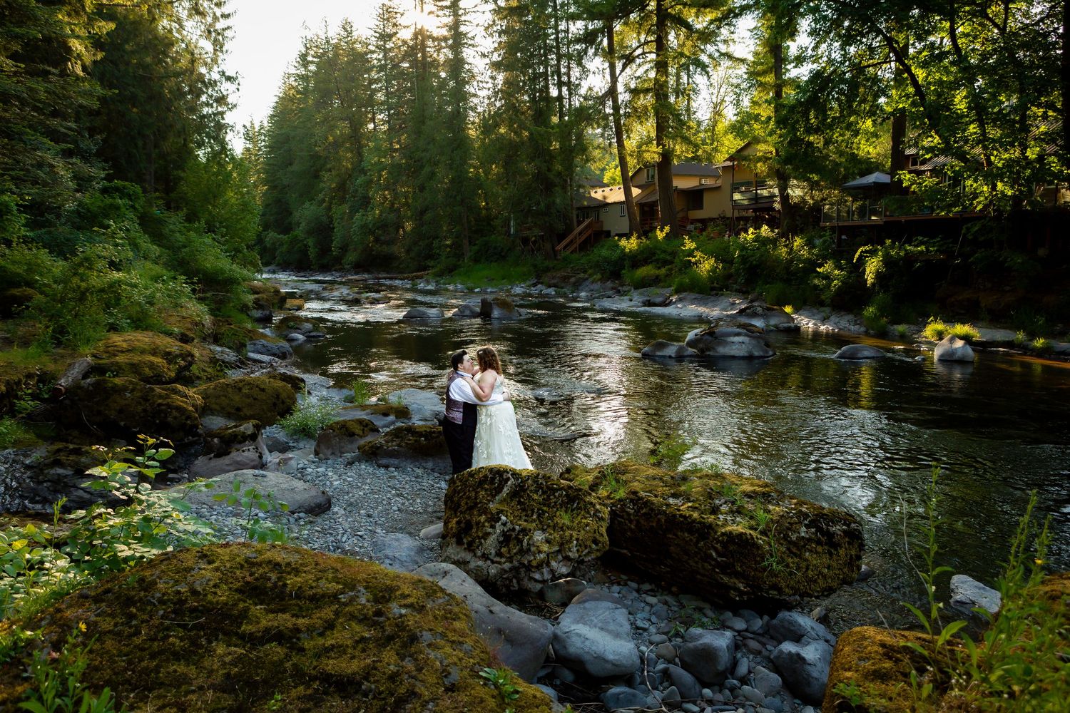 A scenic wedding photography location with a flowing river and forest landscape.