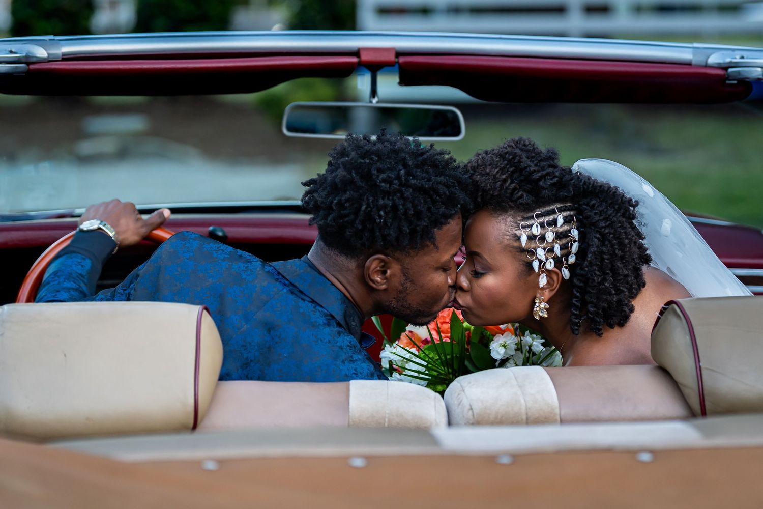 Romantic moments captured in vintage car during wedding celebration.