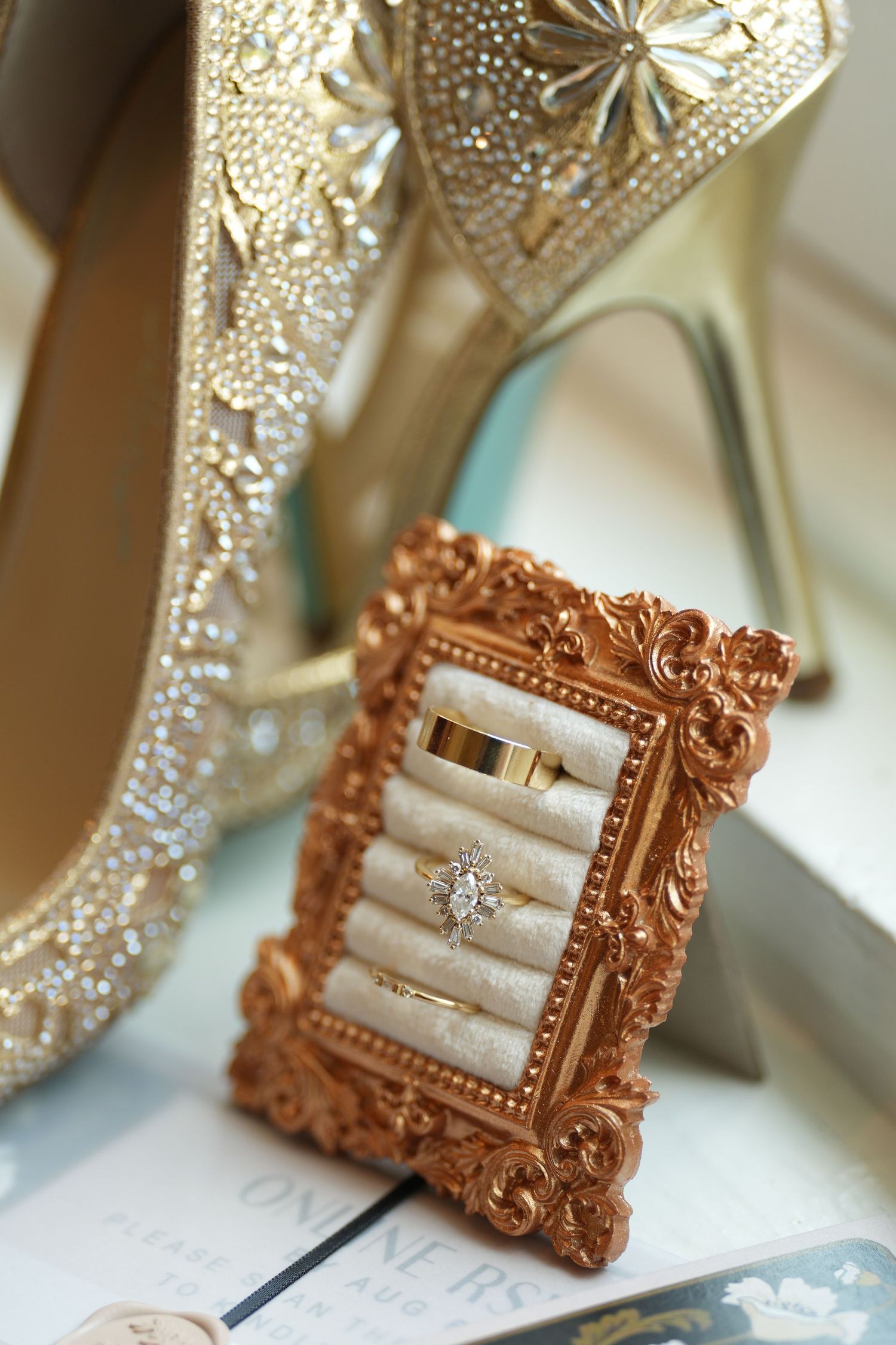 Ornate vintage-style rose gold picture frames with crystal embellishments.