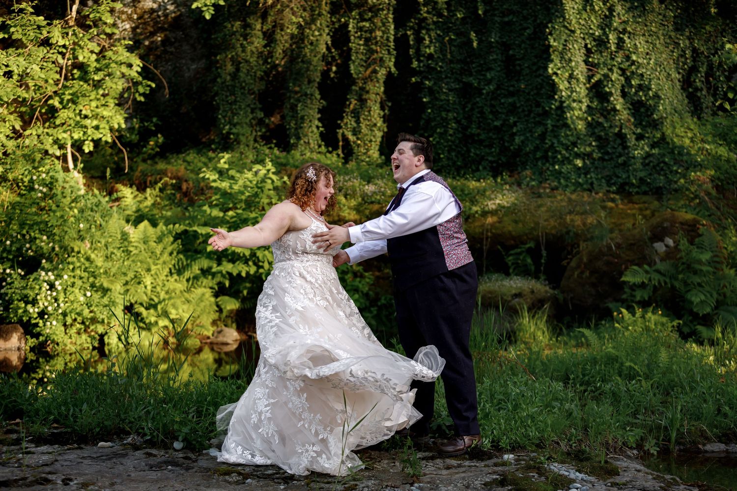 A joyful wedding dance captured in a scenic garden setting.
