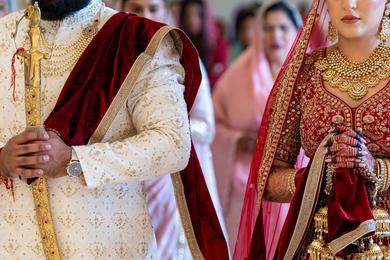 Traditional Indian wedding attire featuring ornate gold embroidery and jewelry details.