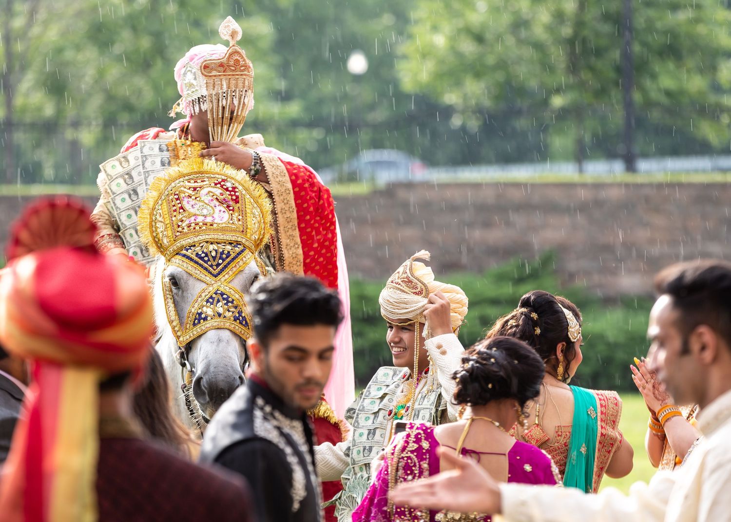 Traditional Indian wedding procession featuring a decorated horse and colorful attire.