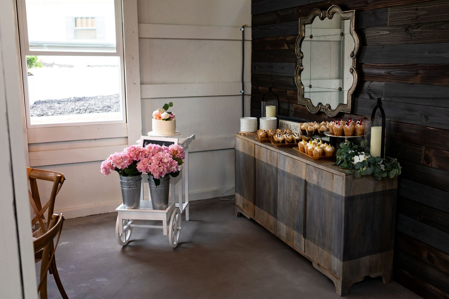 Rustic wooden decor and vintage furniture in a barn style wedding venue with shabby chic details.