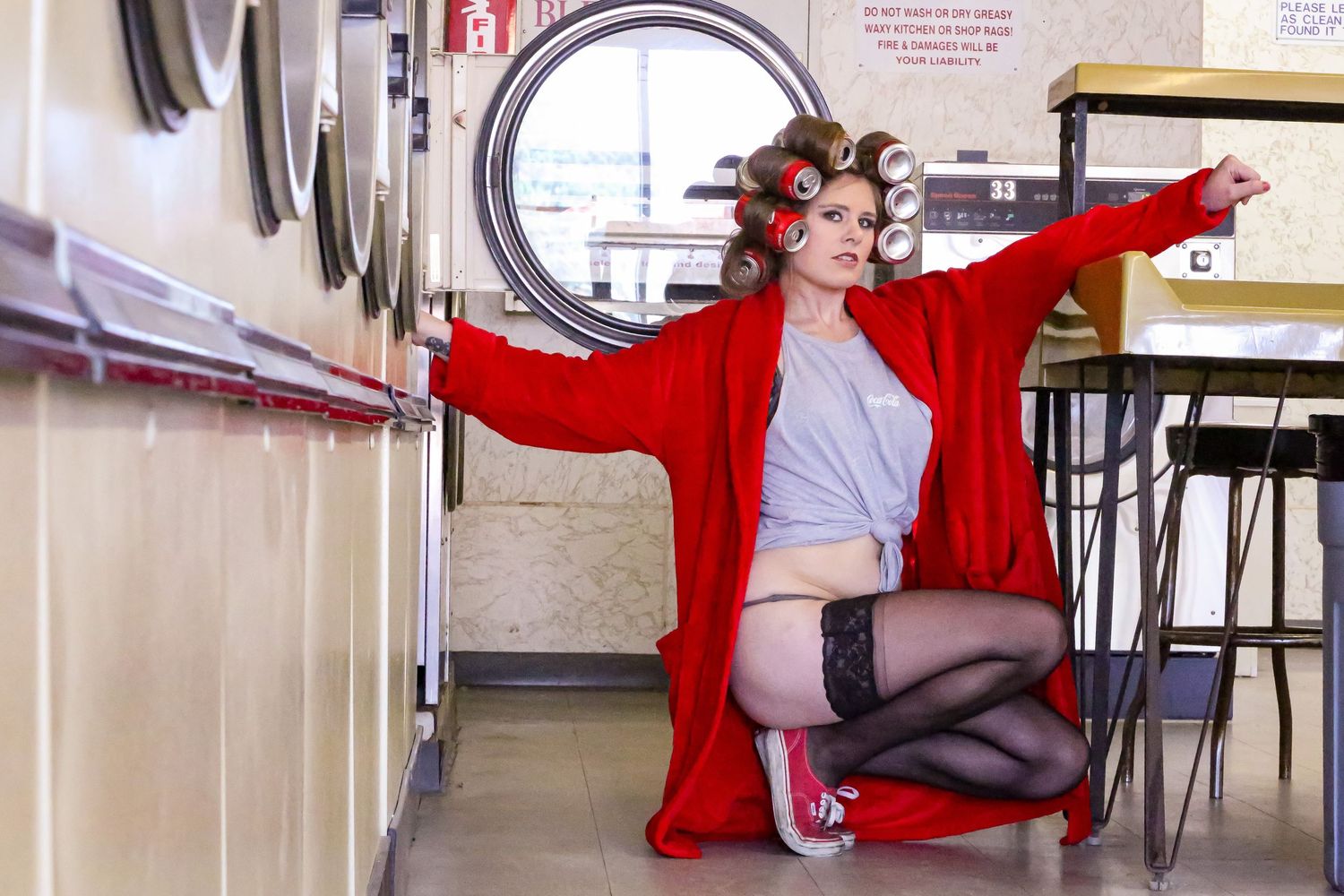 Retro-style laundromat interior featuring classic washing machines and open space.