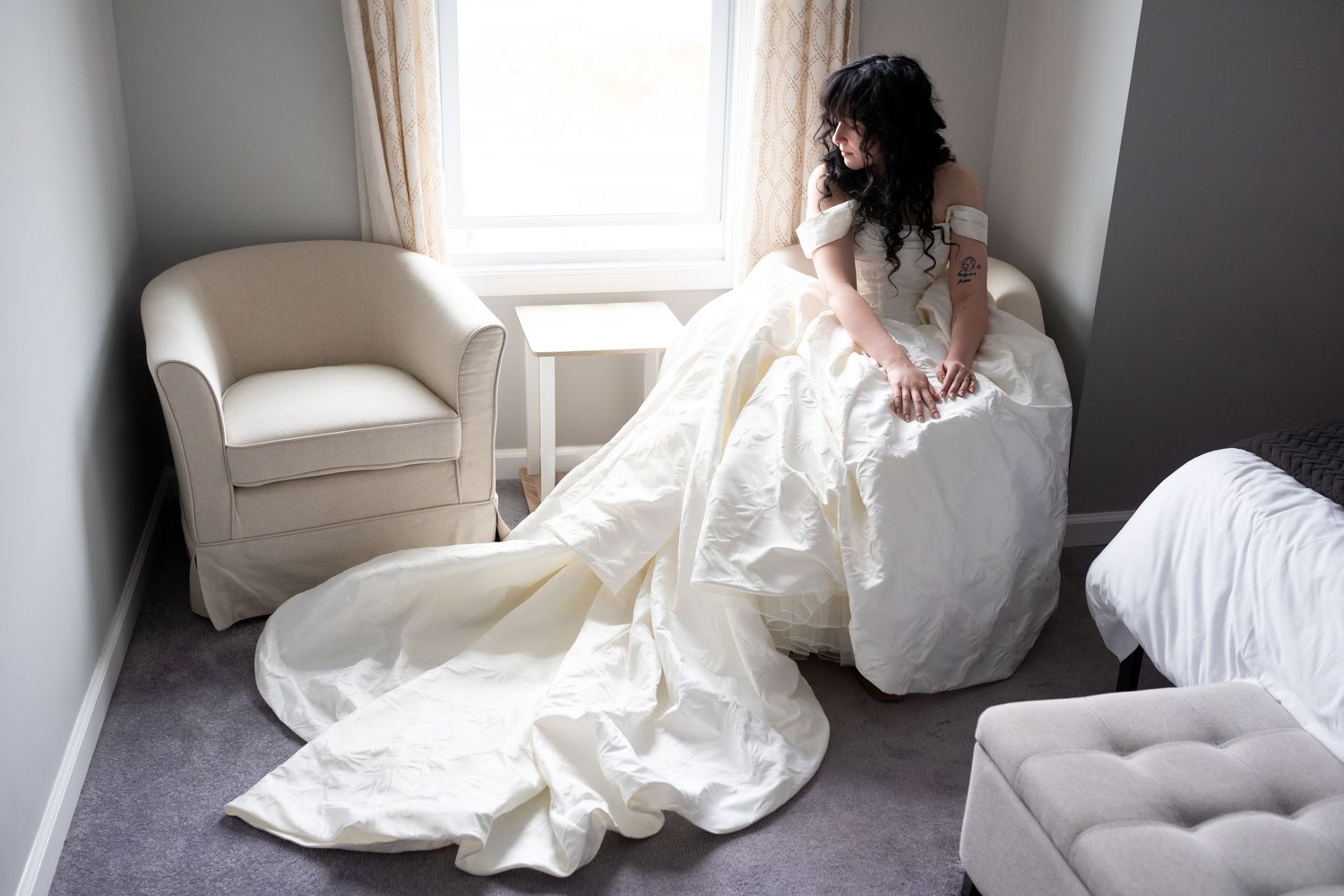 Artistic bridal portraits taken in a bright white room with soft window light.