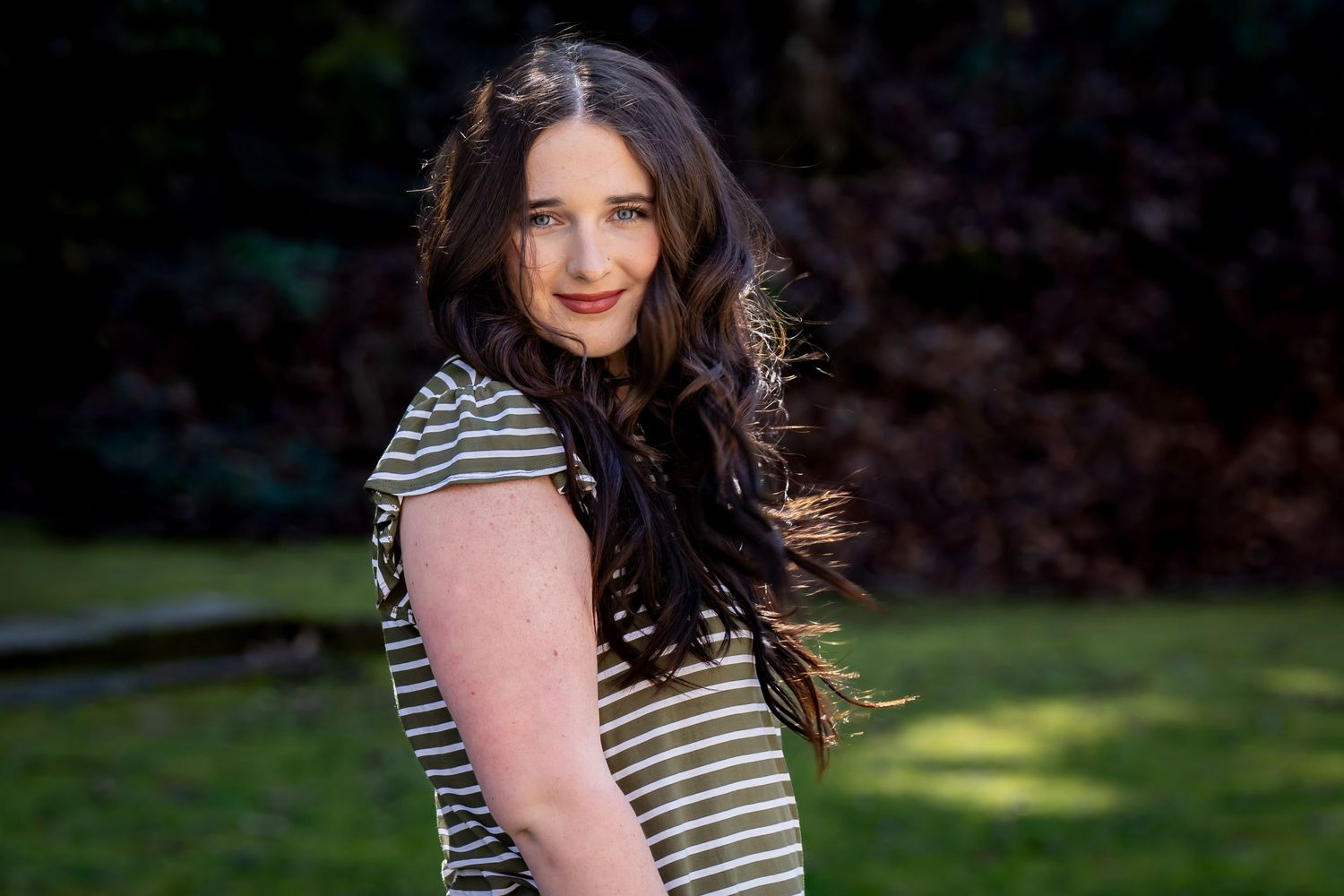Outdoor portrait series featuring striped top and natural lighting.