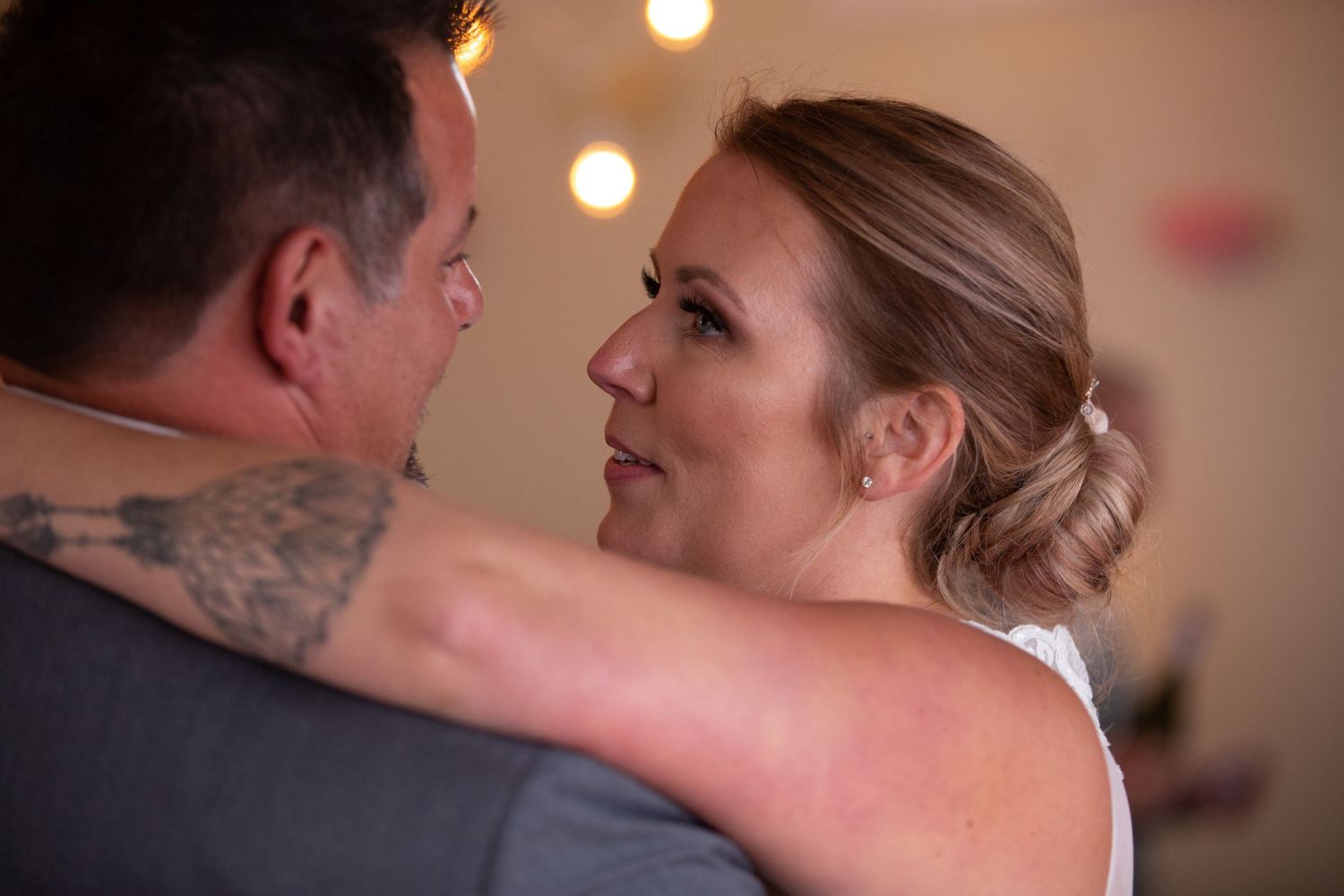A couple shares a romantic moment during their first dance at a wedding reception.