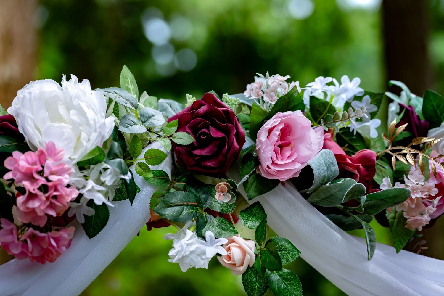 Wedding decoration garland with pink and white flowers arranged horizontally.