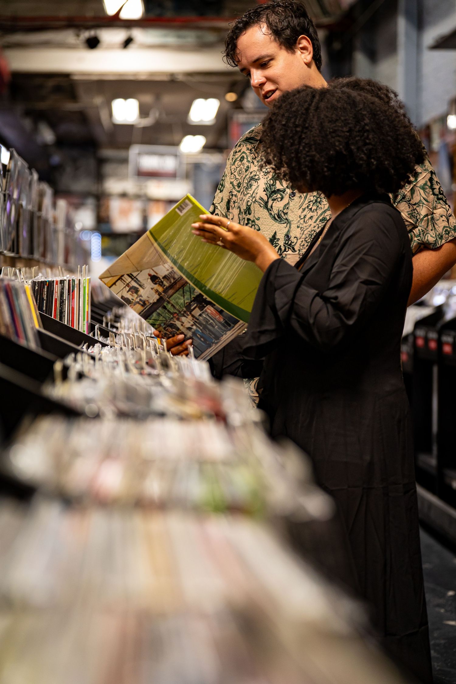 Customers browse through vinyl records in a music store.