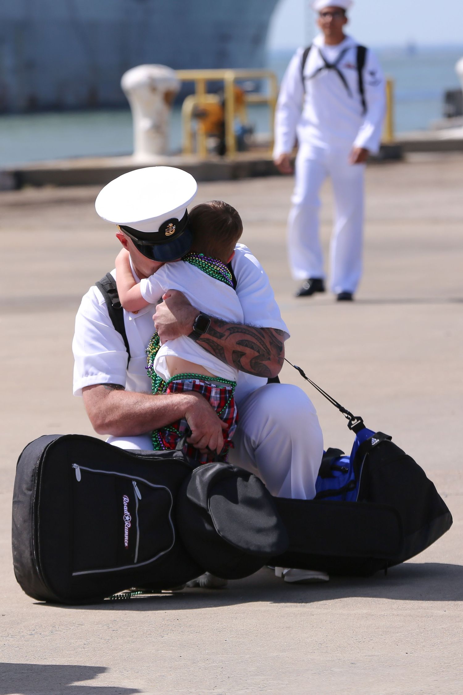 An emotional reunion between a sailor and loved one on a military base.