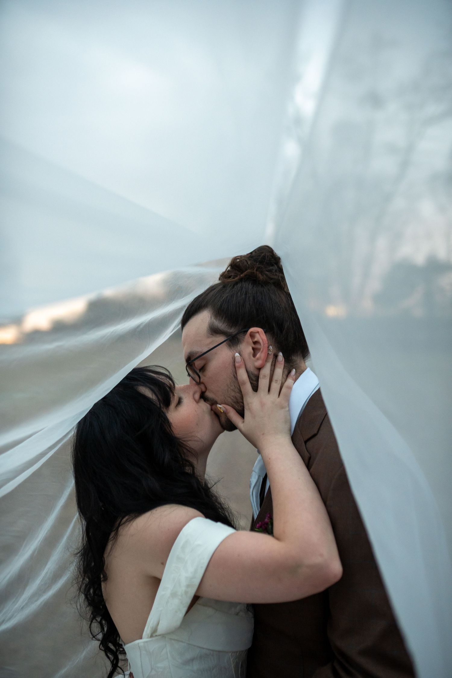 A romantic wedding kiss sequence with dramatic lighting and flowing veil.