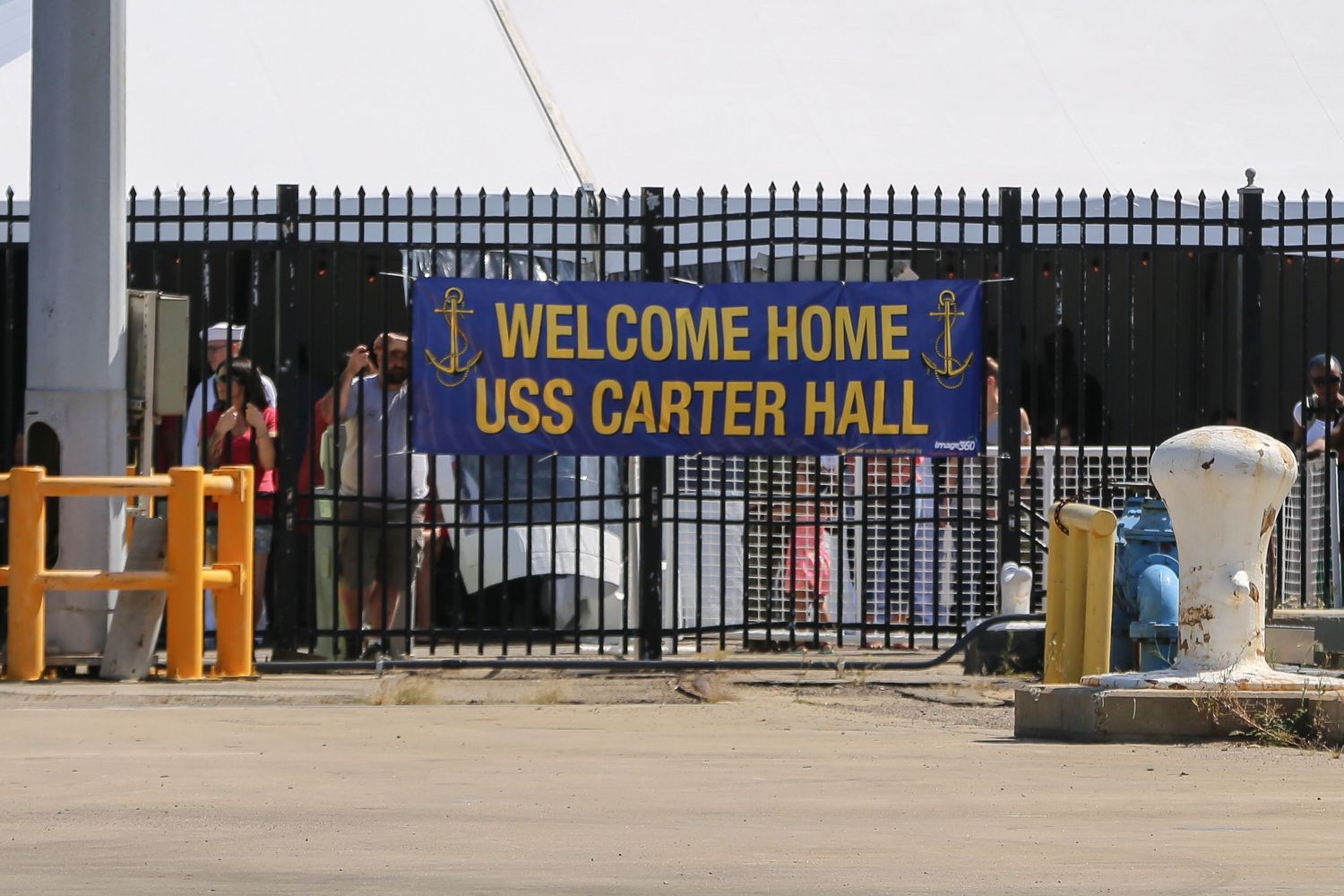 USS Carter Hall naval ship entrance gate with welcome home banner.