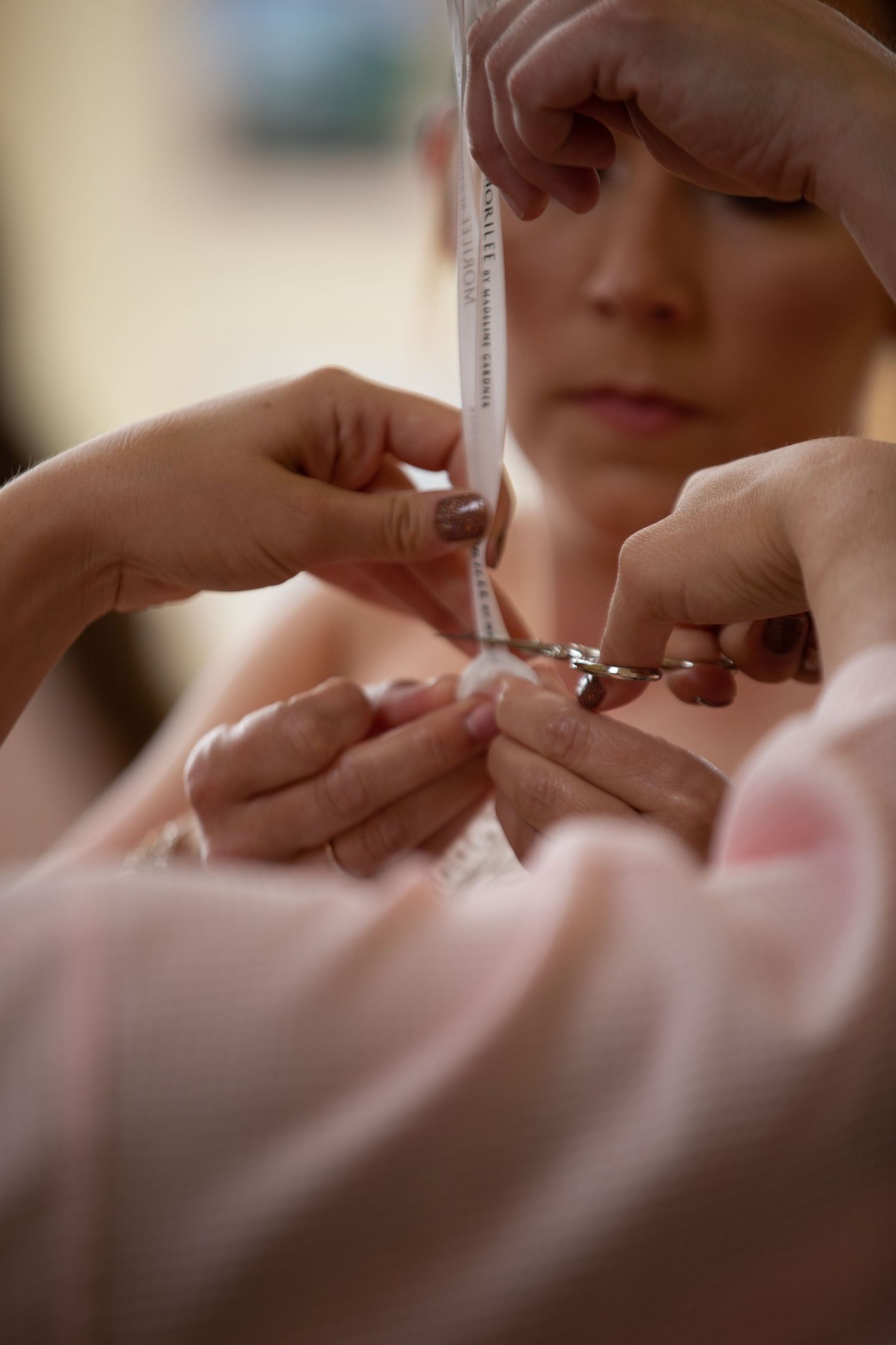 Close up shot of lipstick being applied during wedding makeup preparation.