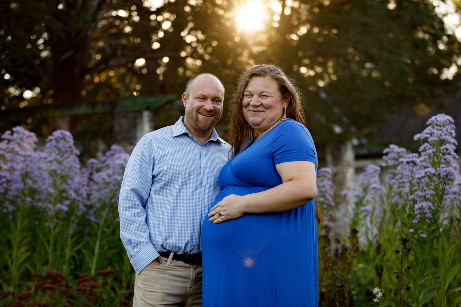 Romantic sunset portrait session with purple wildflowers in the foreground.