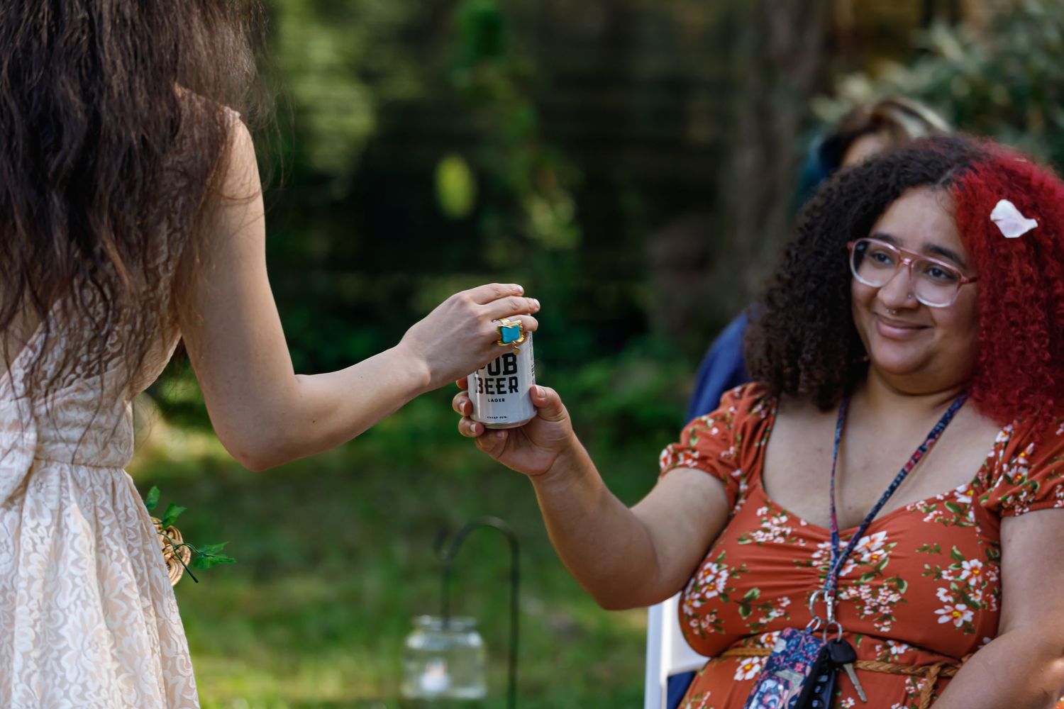 Multiple guests in colorful attire enjoying an outdoor celebration.
