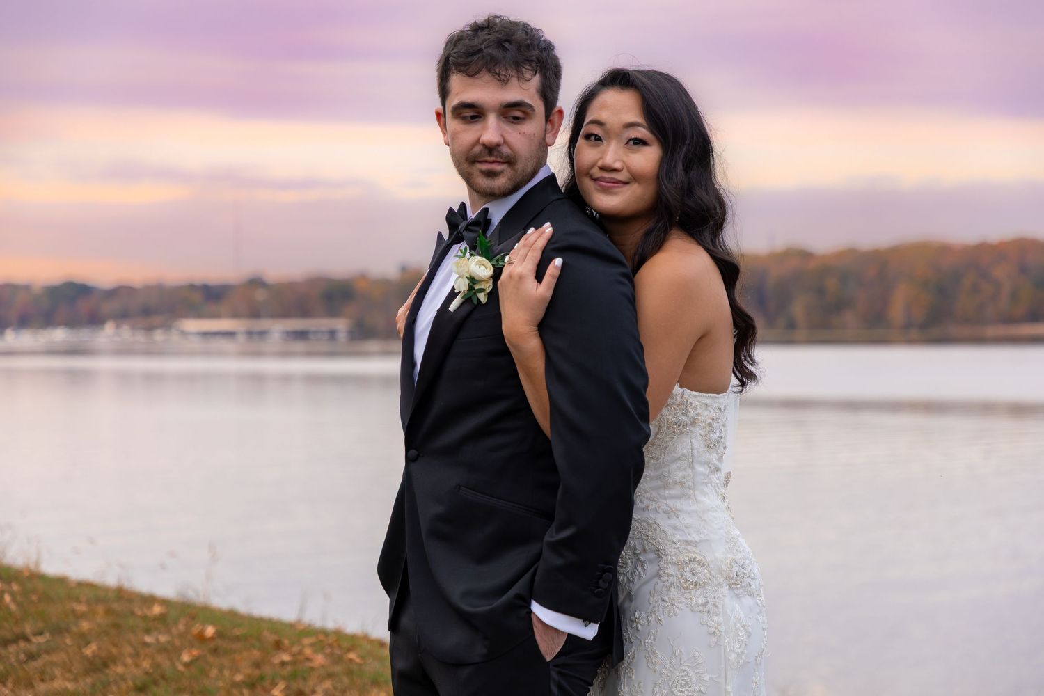 A romantic wedding photoshoot at sunset by a scenic lake.