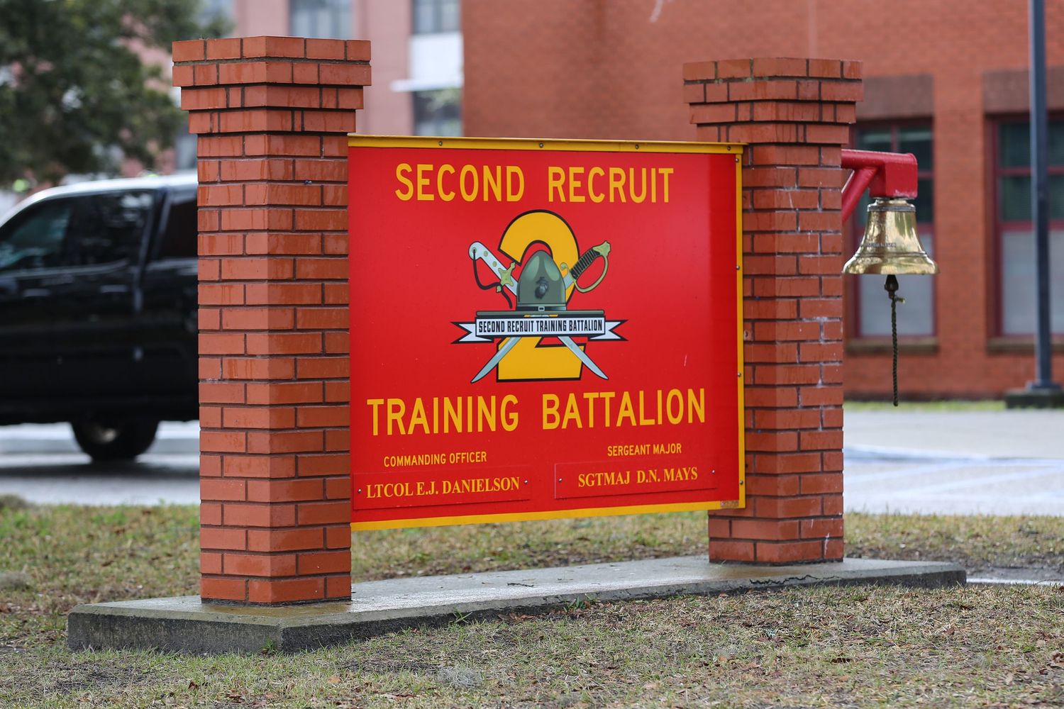 Red brick entrance sign for Second Recruit Training Battalion at military base.