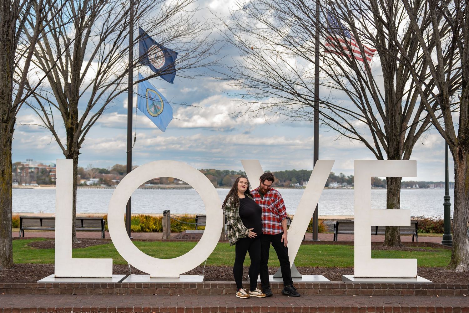 A large LOVE sign installation outdoors with bare trees in the background.