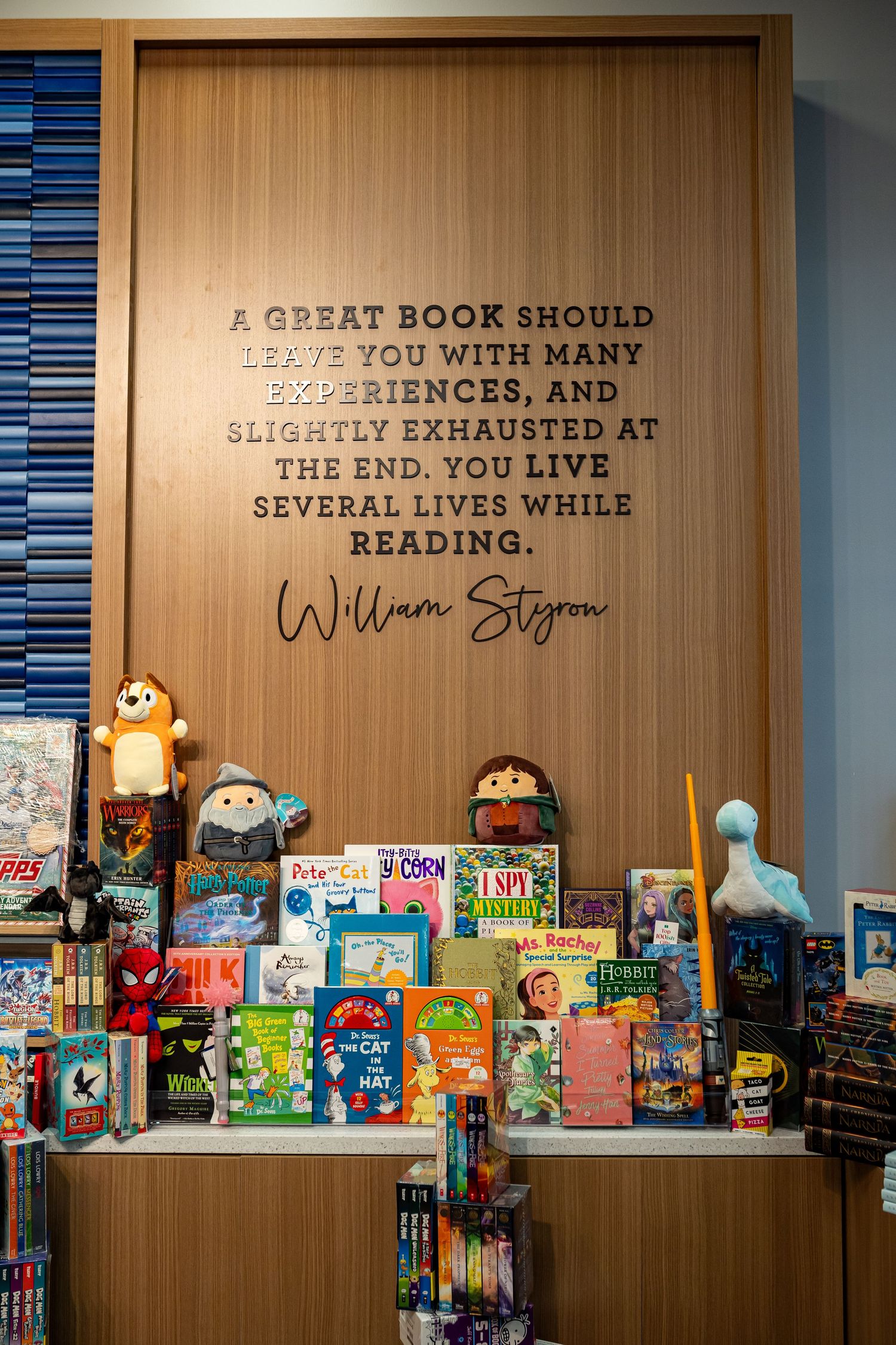Bookstore display with William Styron quote and children's books on wooden shelving.