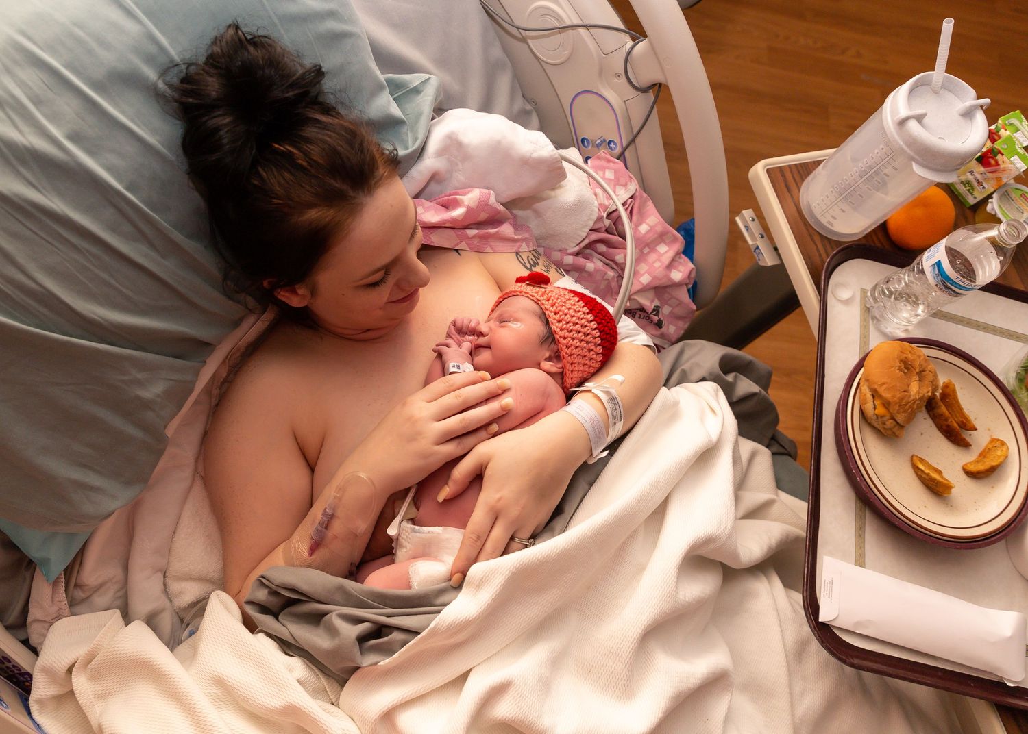 Hospital scene showing first moments after birth with medical staff attending to newborn.