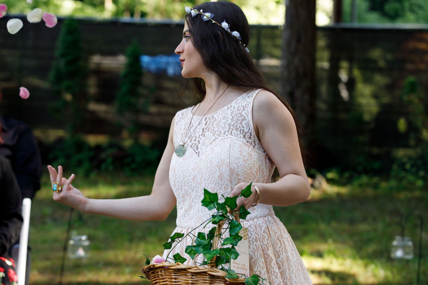 Several candid shots of someone in a white dress dancing joyfully outdoors with flower petals falling.